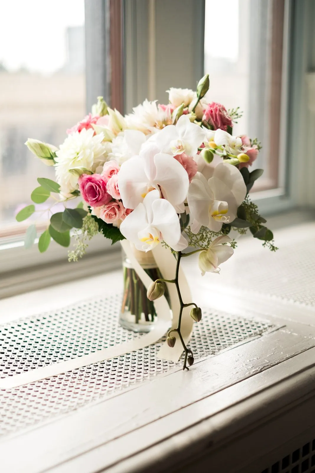 Cascading orchid bouquet on the bridal suite windowsill at the Greysolon Plaza — Tim Larsen Photography, Duluth MN