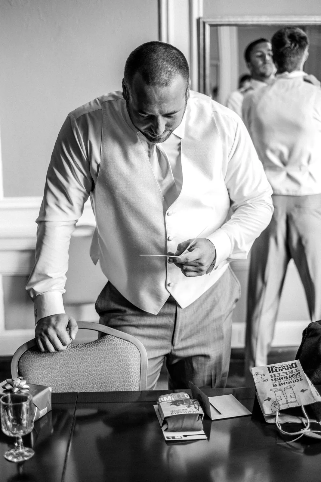 Groom reading a handwritten note from his bride at the Greysolon Plaza — Tim Larsen Photography, Duluth MN