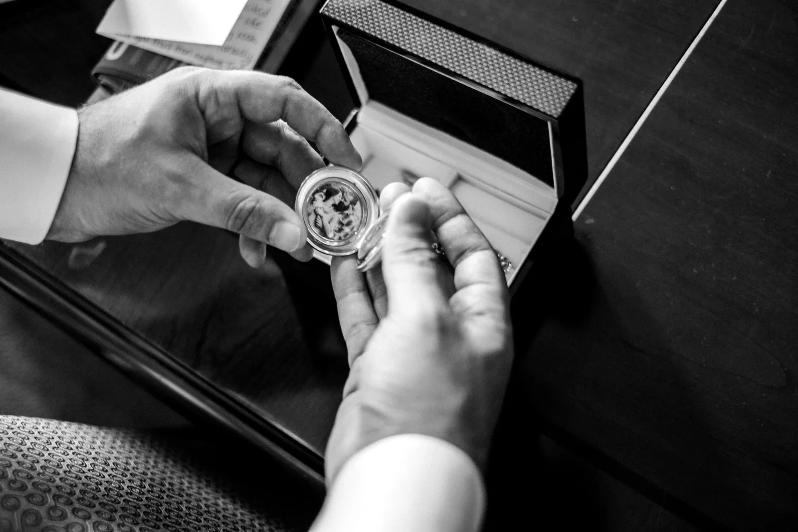 Overhead keepsake locket exchange beside an open gift box — tender pre-ceremony detail at the Greysolon Plaza — Tim Larsen Photography, Duluth MN