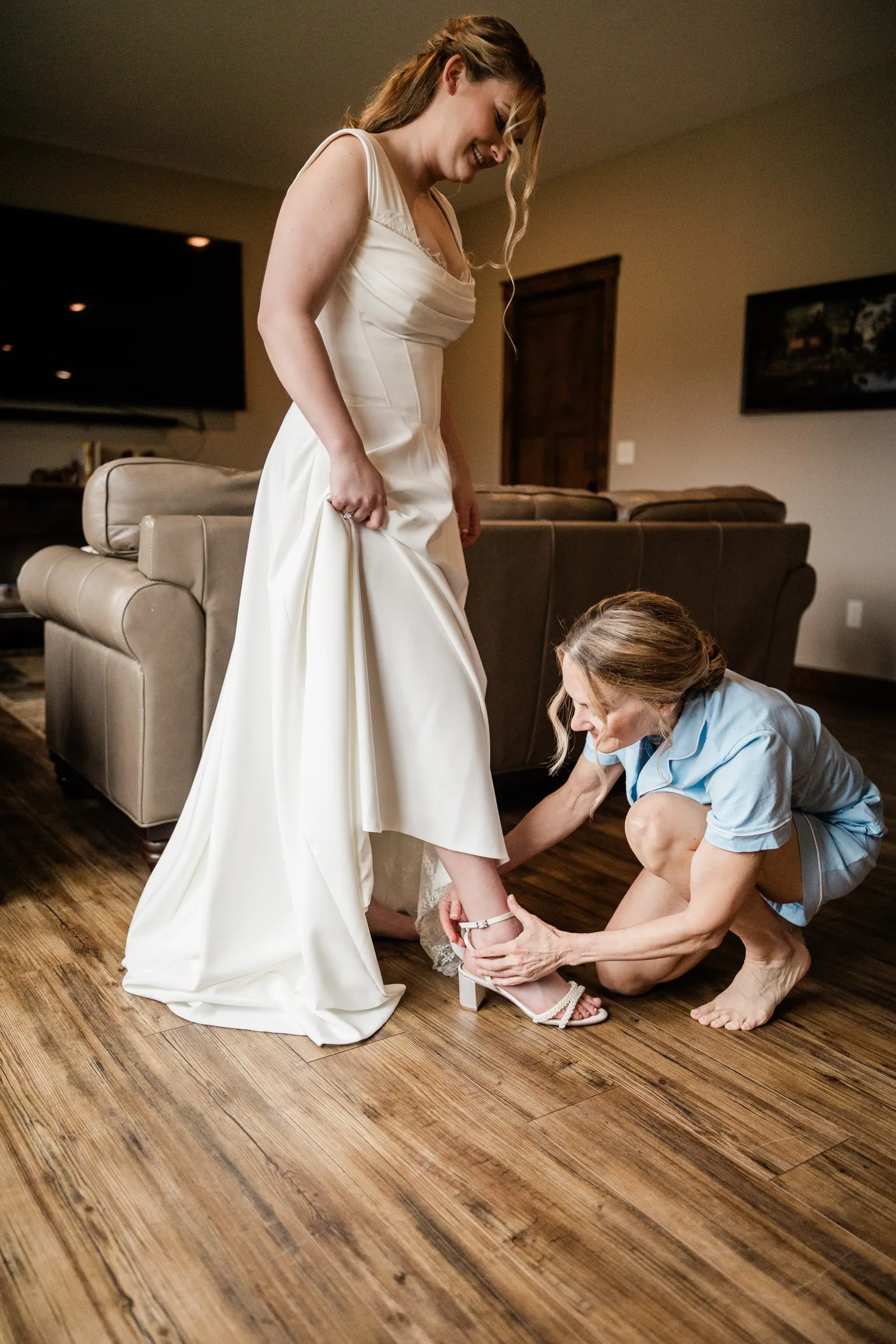 Lauren smiles as her bridal shoe is fastened in the Garden Cottages — Tim Larsen Photography, Brainerd Lakes MN