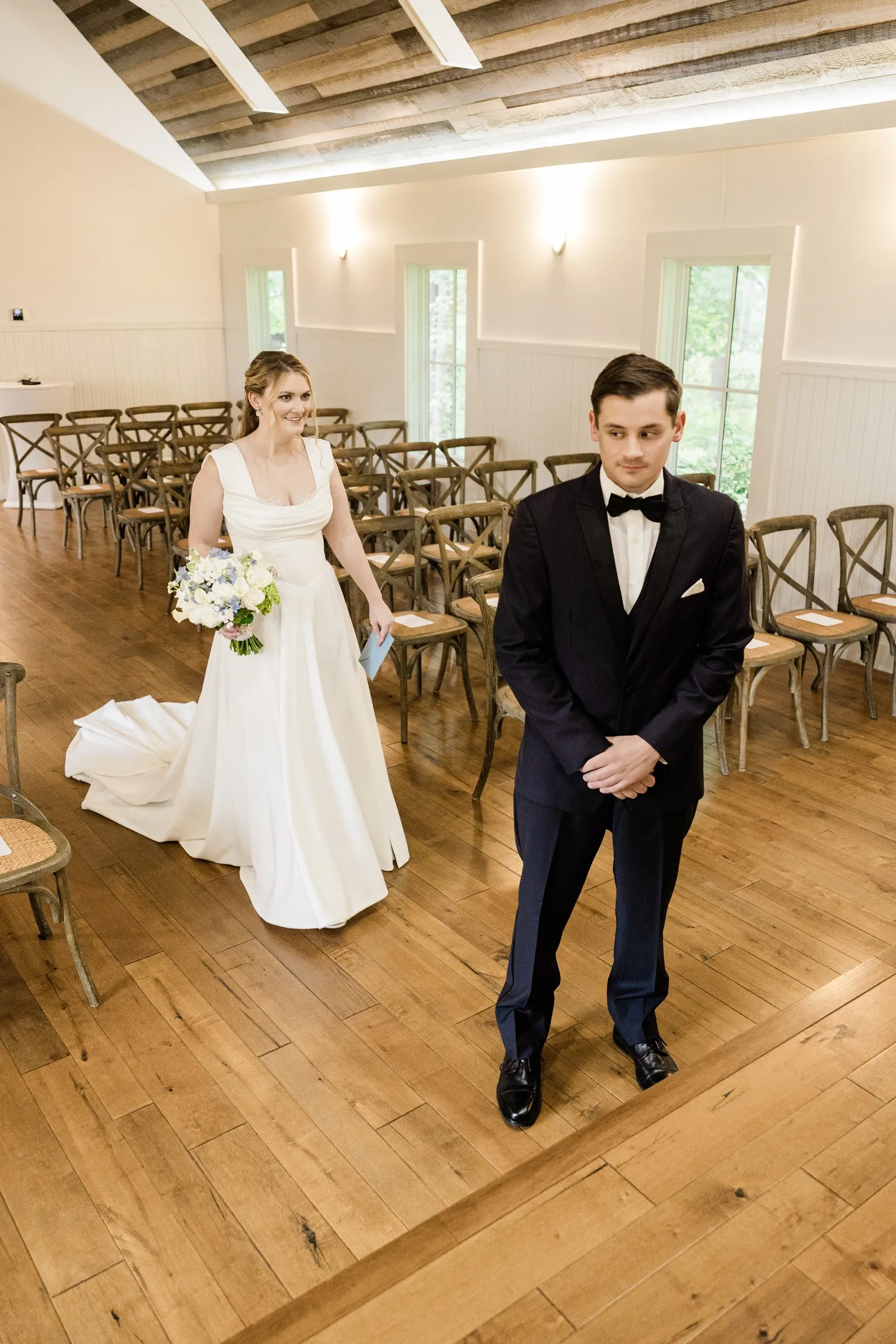 Lauren approaches Noah from behind for their first look in the Grand View Lodge Chapel — Tim Larsen Photography, Brainerd Lakes MN