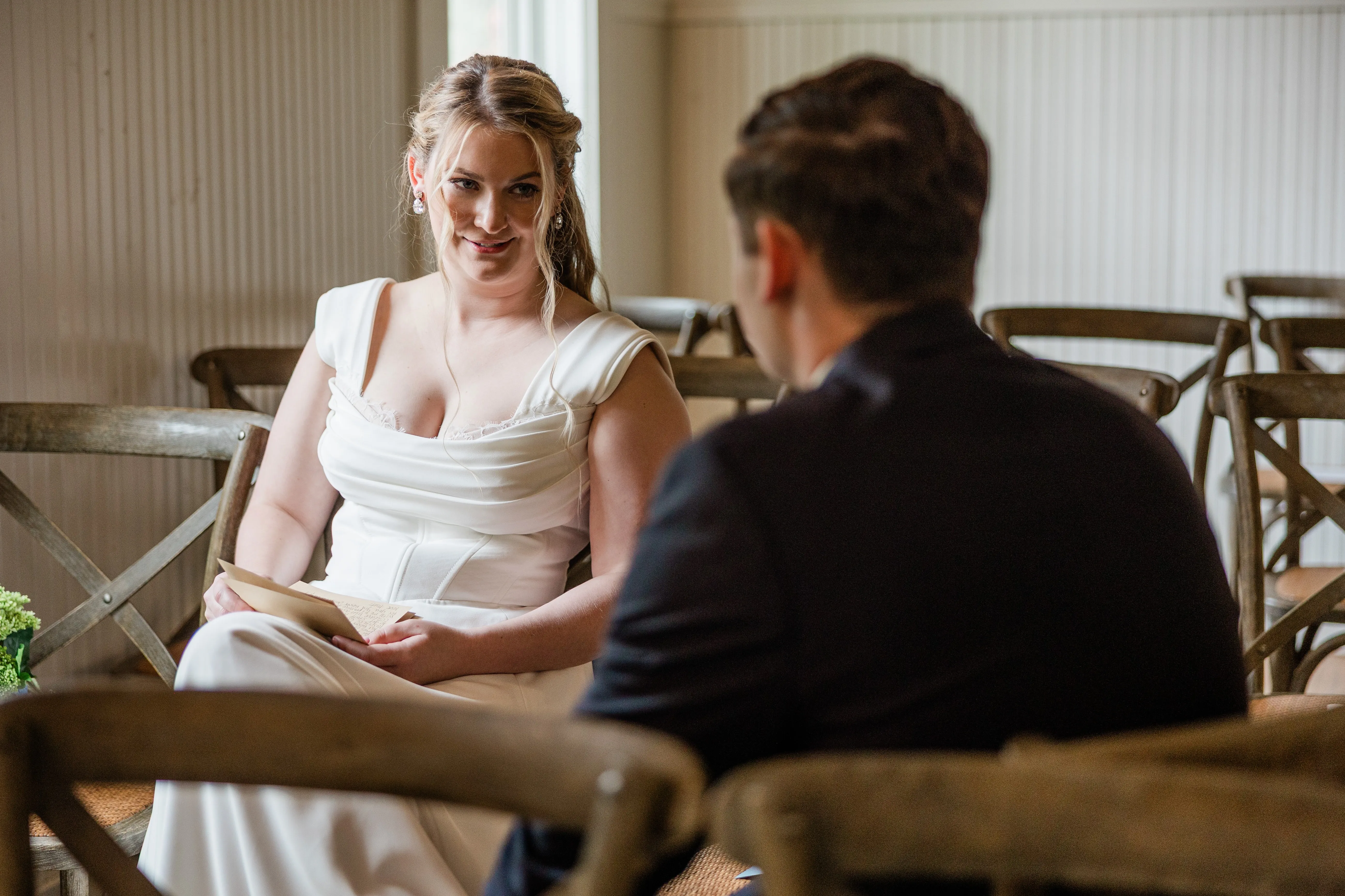 Lauren smiles at Noah with a handwritten page in her lap — Tim Larsen Photography, Brainerd Lakes MN