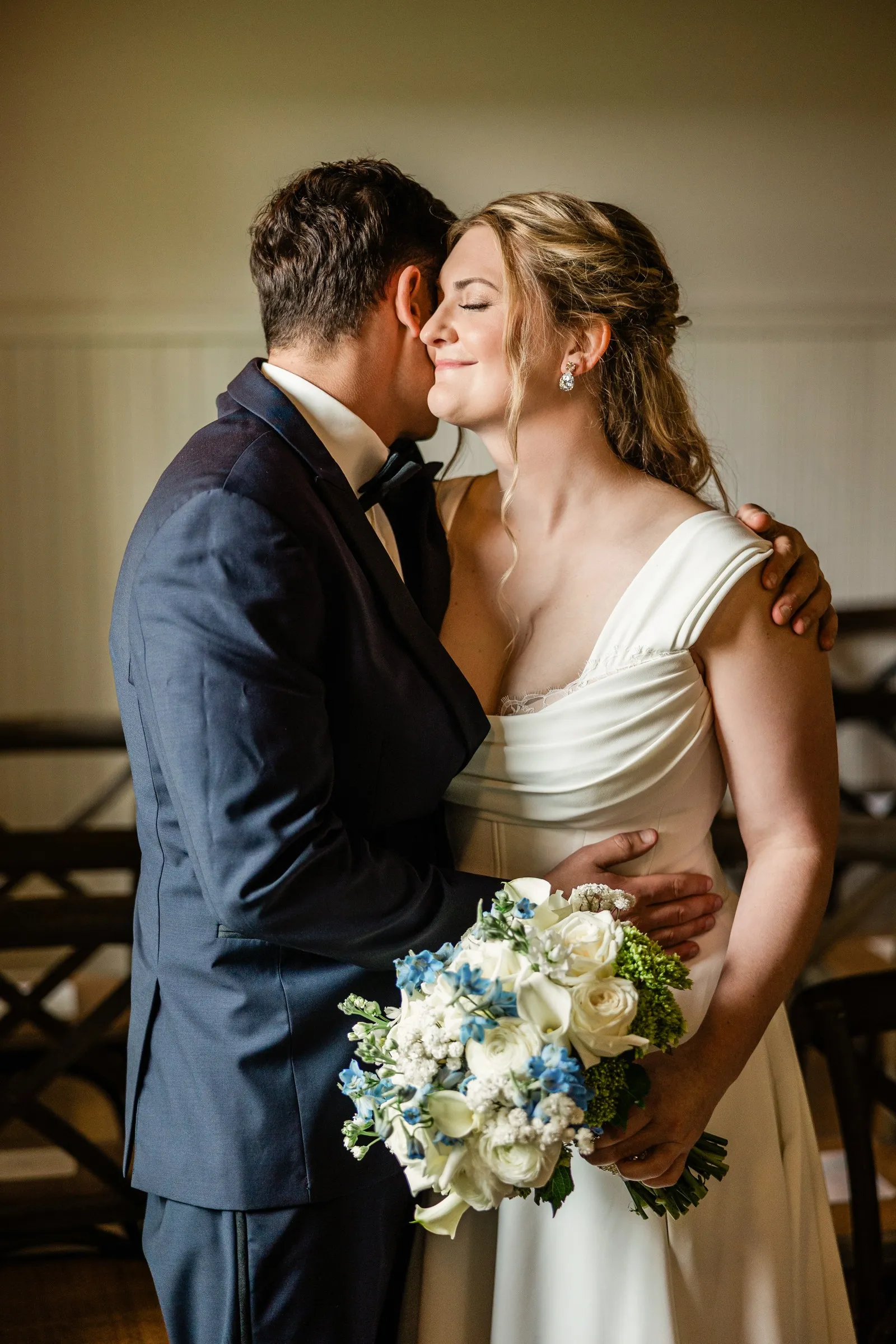 Lauren closes her eyes as Noah leans close and wraps his arm around her — Tim Larsen Photography, Brainerd Lakes MN
