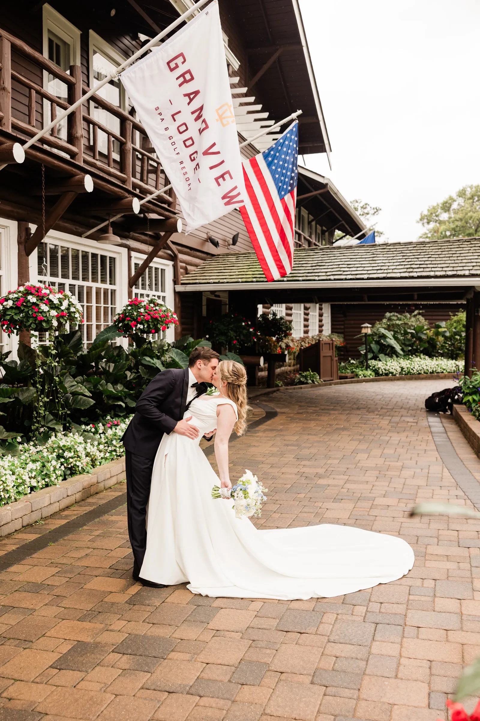 Noah dips Lauren for a kiss outside the main entrance to Grand View Lodge — Tim Larsen Photography, Brainerd Lakes MN