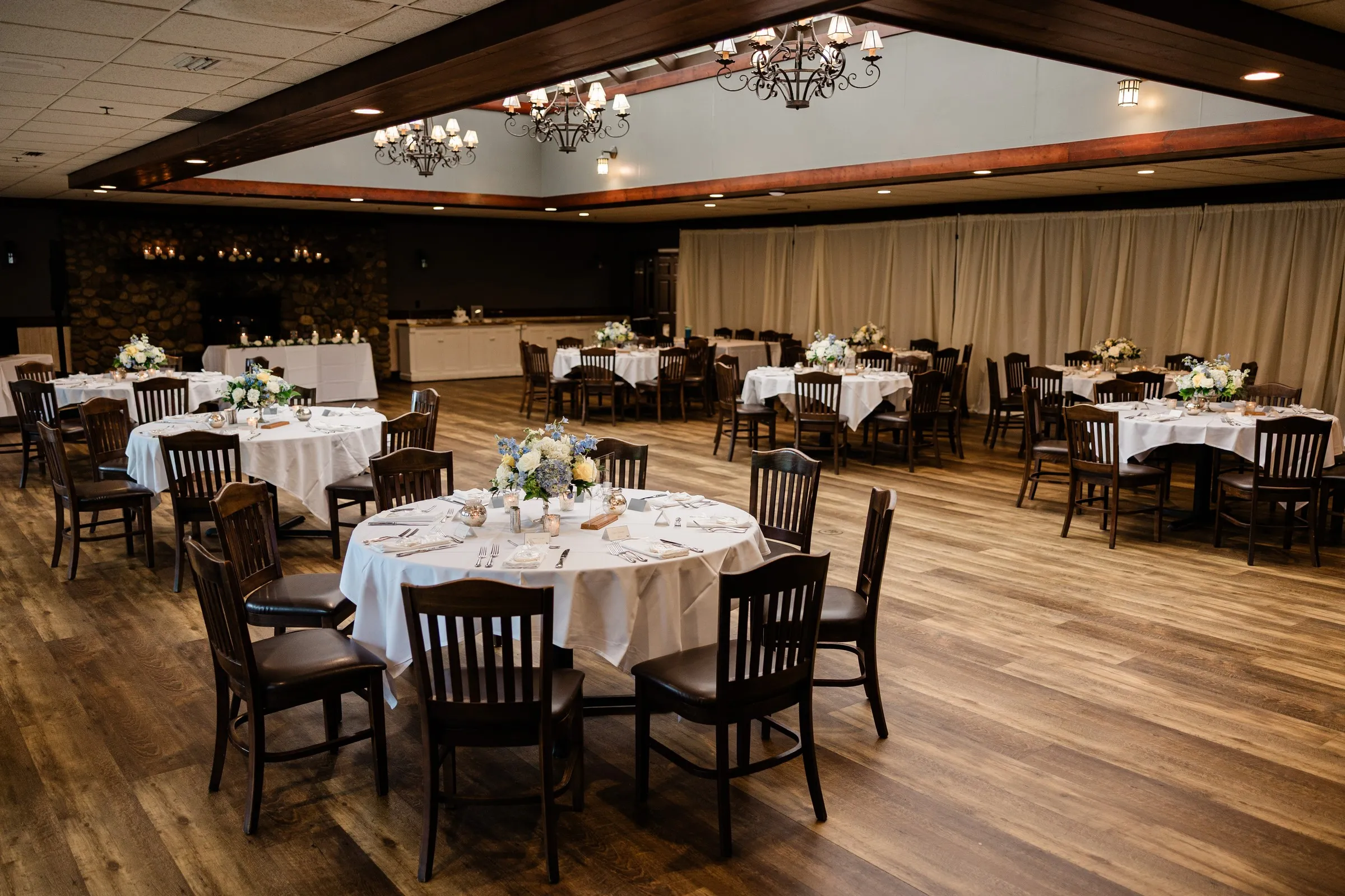 Round tables, white linens and dark wooden chairs fill the Heritage Room at Grand View Lodge — Tim Larsen Photography, Brainerd Lakes MN