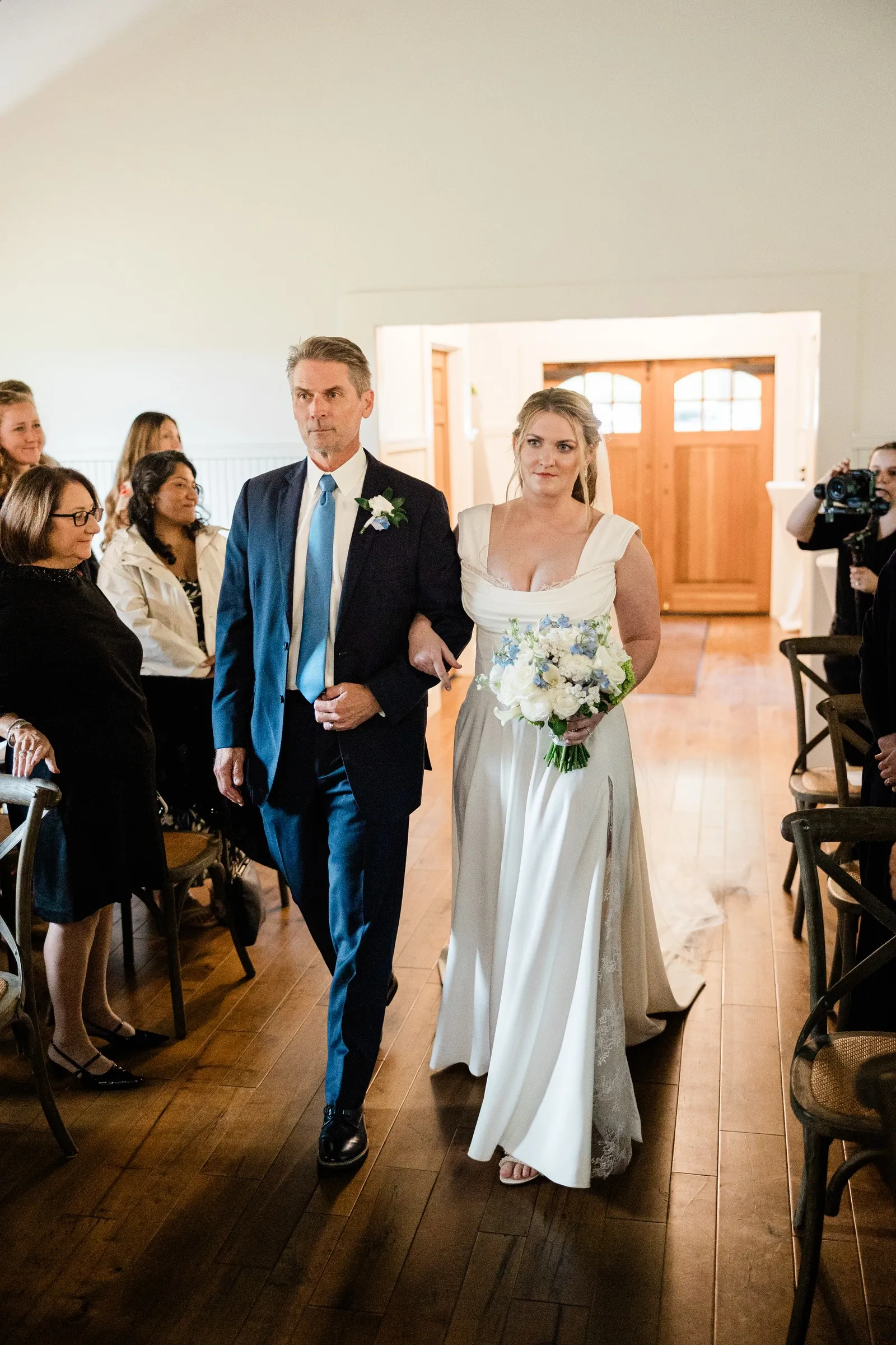 Lauren walks down the Chapel aisle with a man in a blue suit — Tim Larsen Photography, Brainerd Lakes MN