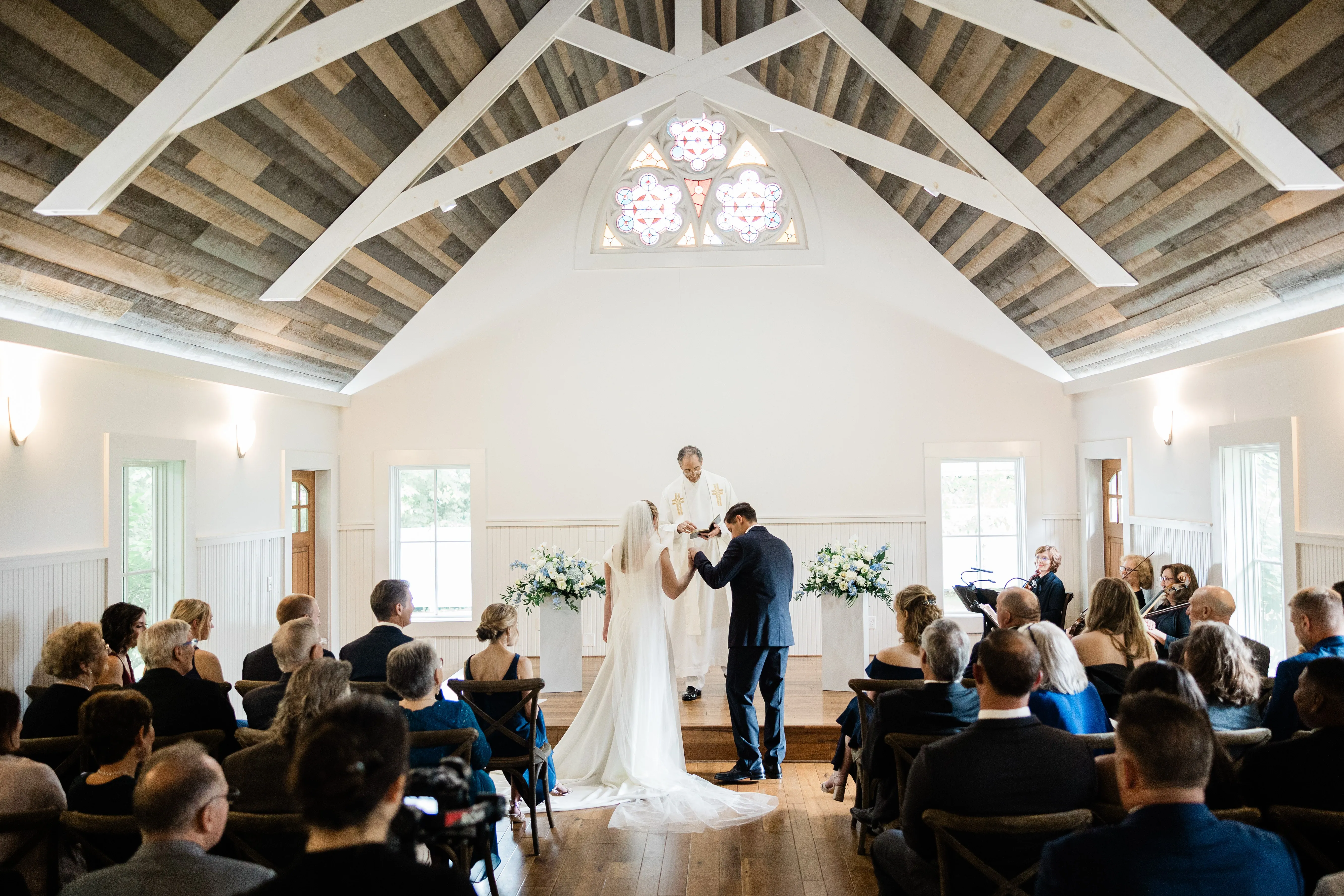 Lauren and Noah’s ceremony beneath the vaulted ceiling of the Grand View Lodge Chapel — Tim Larsen Photography, Brainerd Lakes MN
