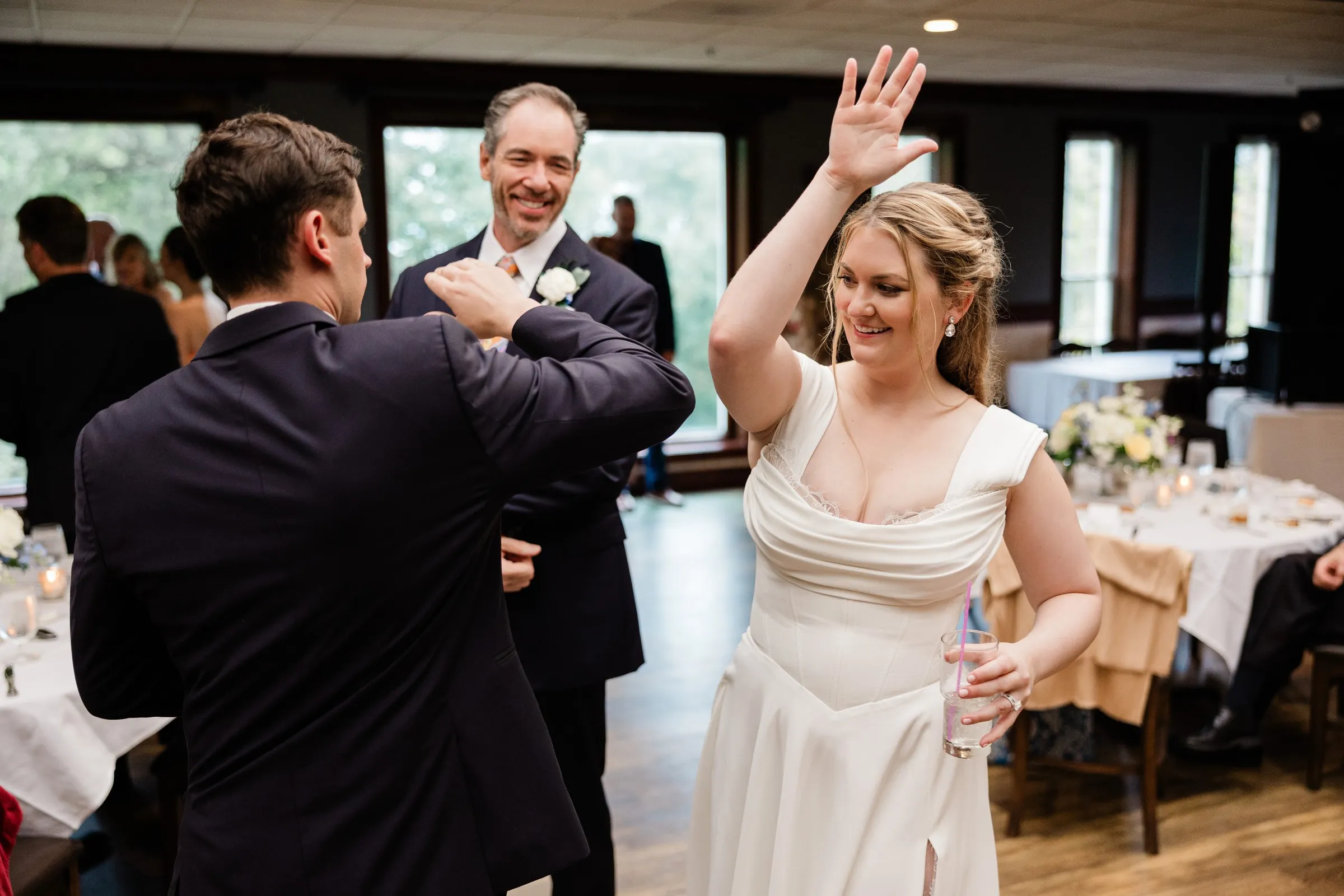 Lauren waves as she and Noah enter their reception at Grand View Lodge — Tim Larsen Photography, Brainerd Lakes MN