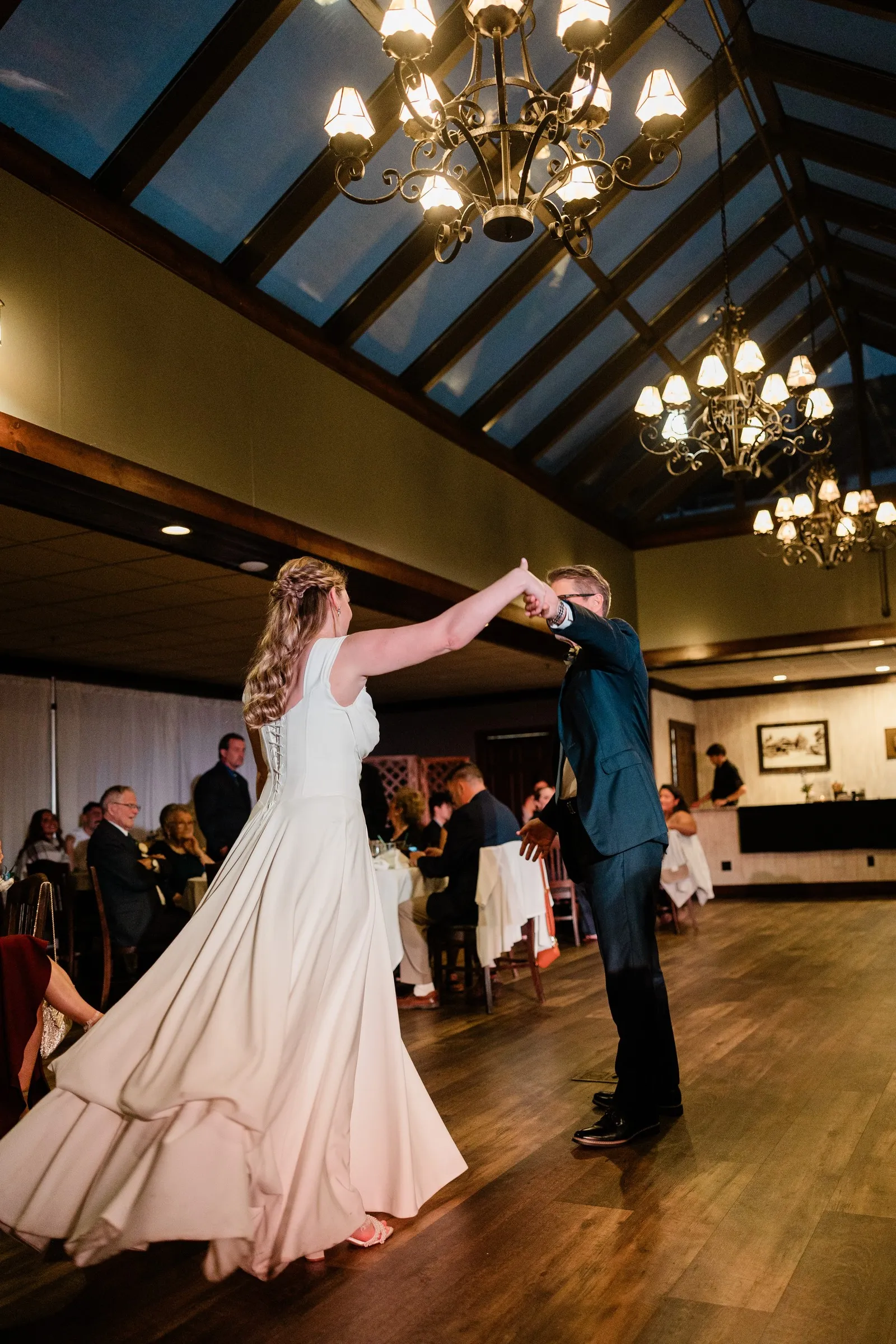 Lauren twirls beneath her dance partner’s raised hand in the Heritage Room — Tim Larsen Photography, Brainerd Lakes MN