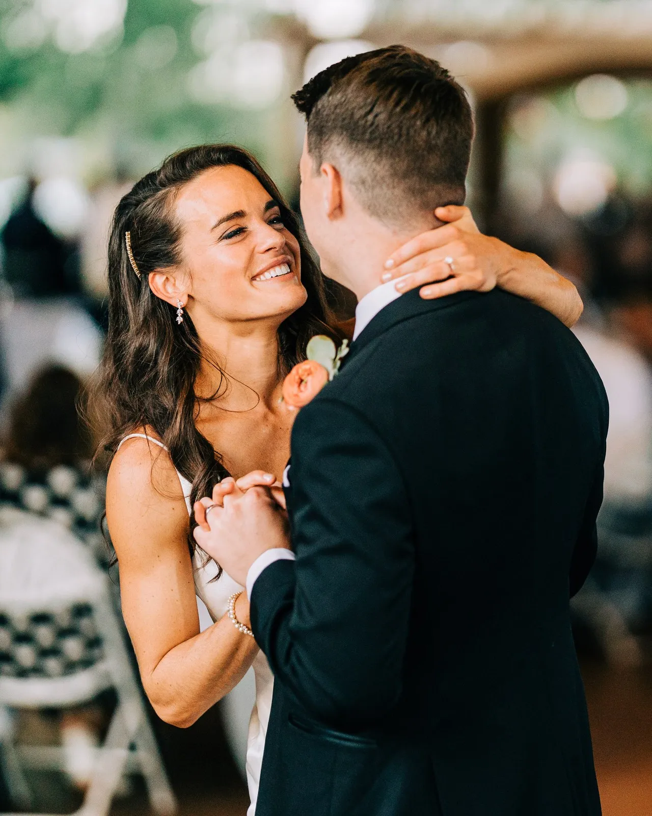 Madison smiles up at Josh, her hand on the back of his neck, during their first dance in the Madden's reception pavilion — Tim Larsen Photography, Brainerd Lakes MN