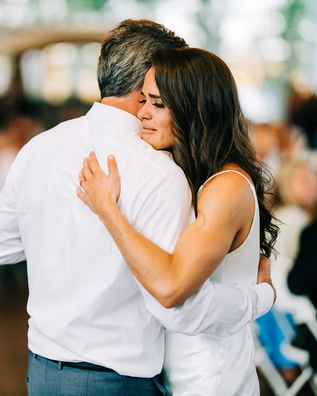 Madison rests her face on her father's shoulder, eyes closed and tears welling, as they share a dance — Tim Larsen Photography, Brainerd Lakes MN
