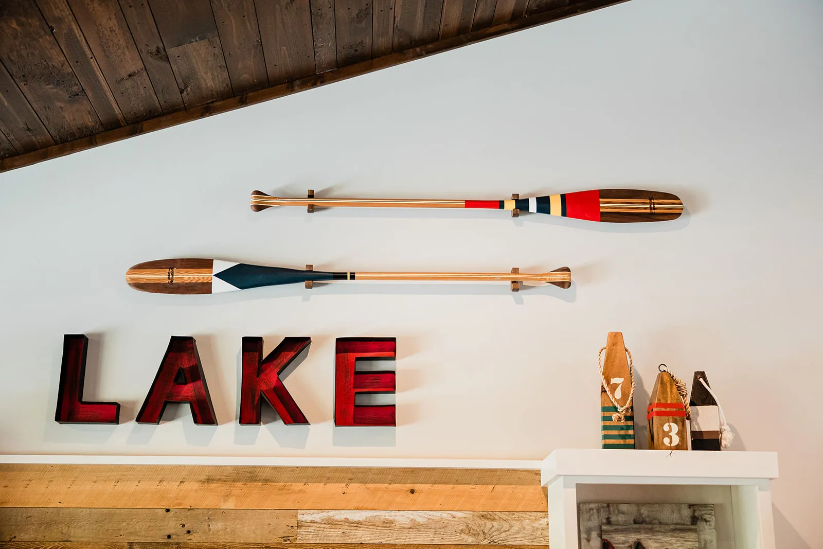 Lake house decor with painted oars and LAKE letters — Tim Larsen Photography, Brainerd Lakes MN