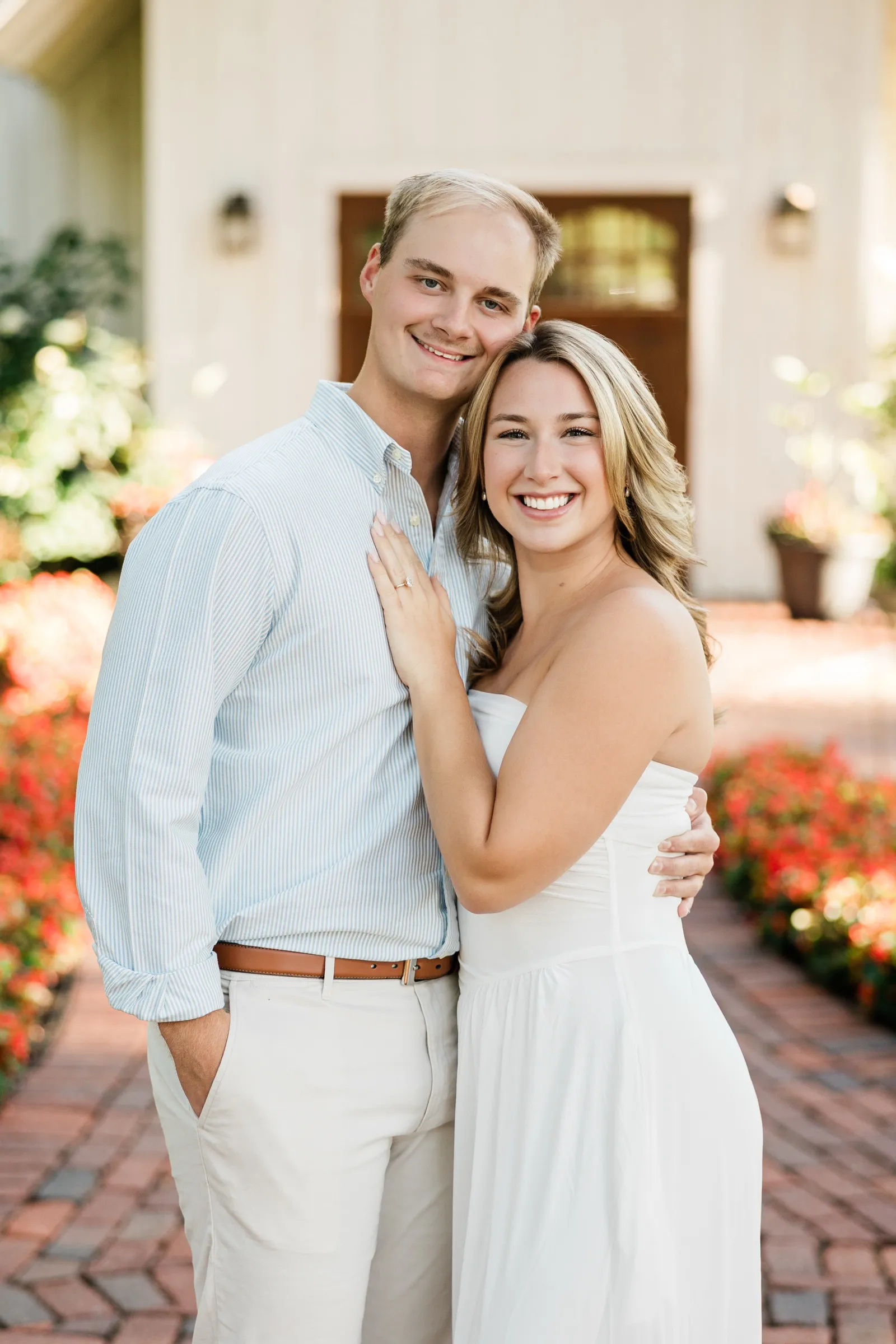 Olivia and Adam smile cheek to cheek, her ring hand resting on his chest — Tim Larsen Photography