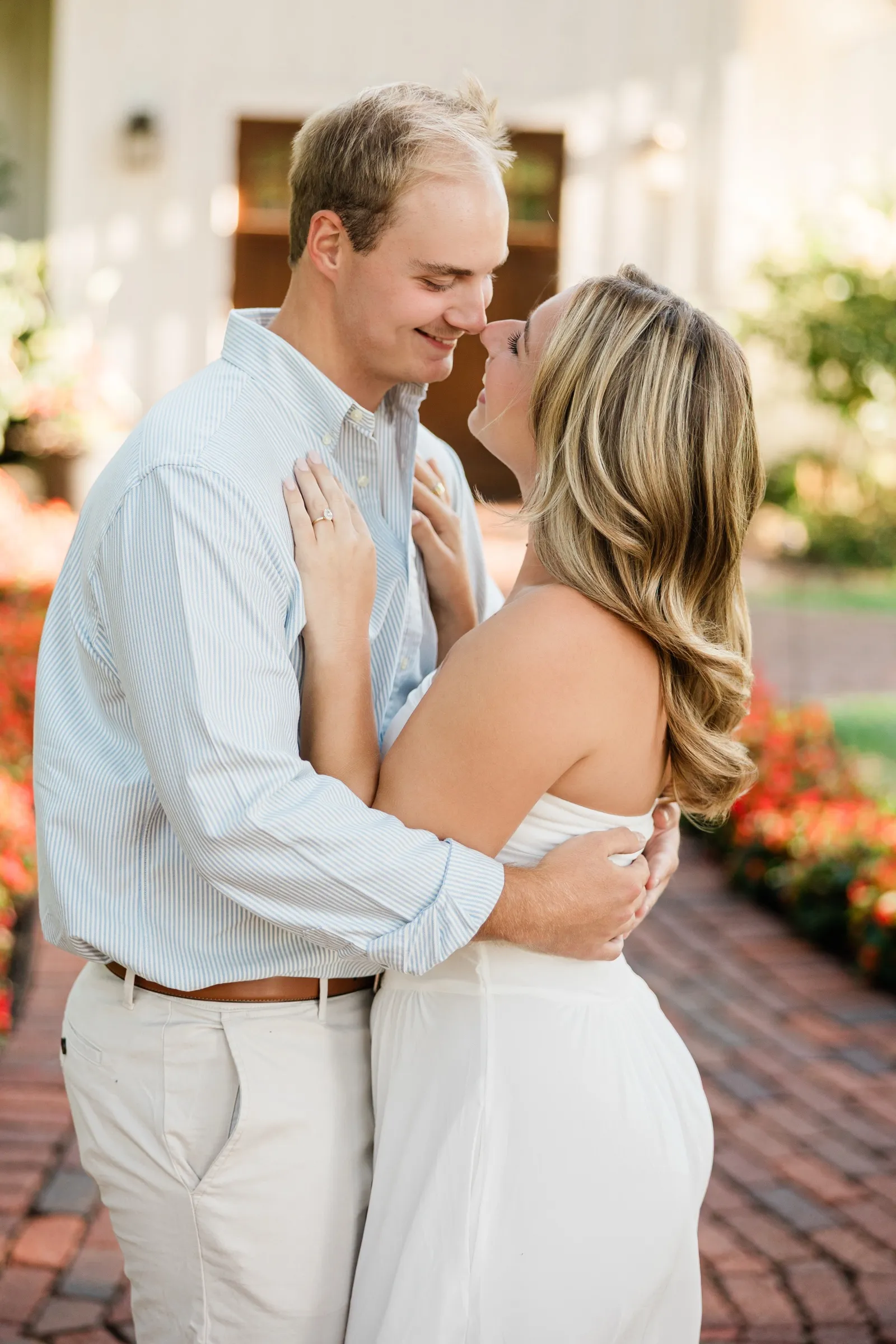 Olivia and Adam lean in nose to nose on the chapel path, both mid-smile — Tim Larsen Photography