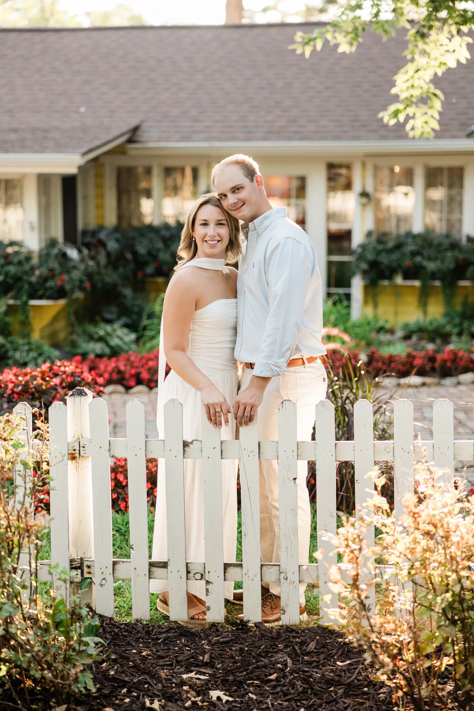 Olivia and Adam lean cheek to cheek behind the picket gate at the Italian Gardens — Tim Larsen Photography