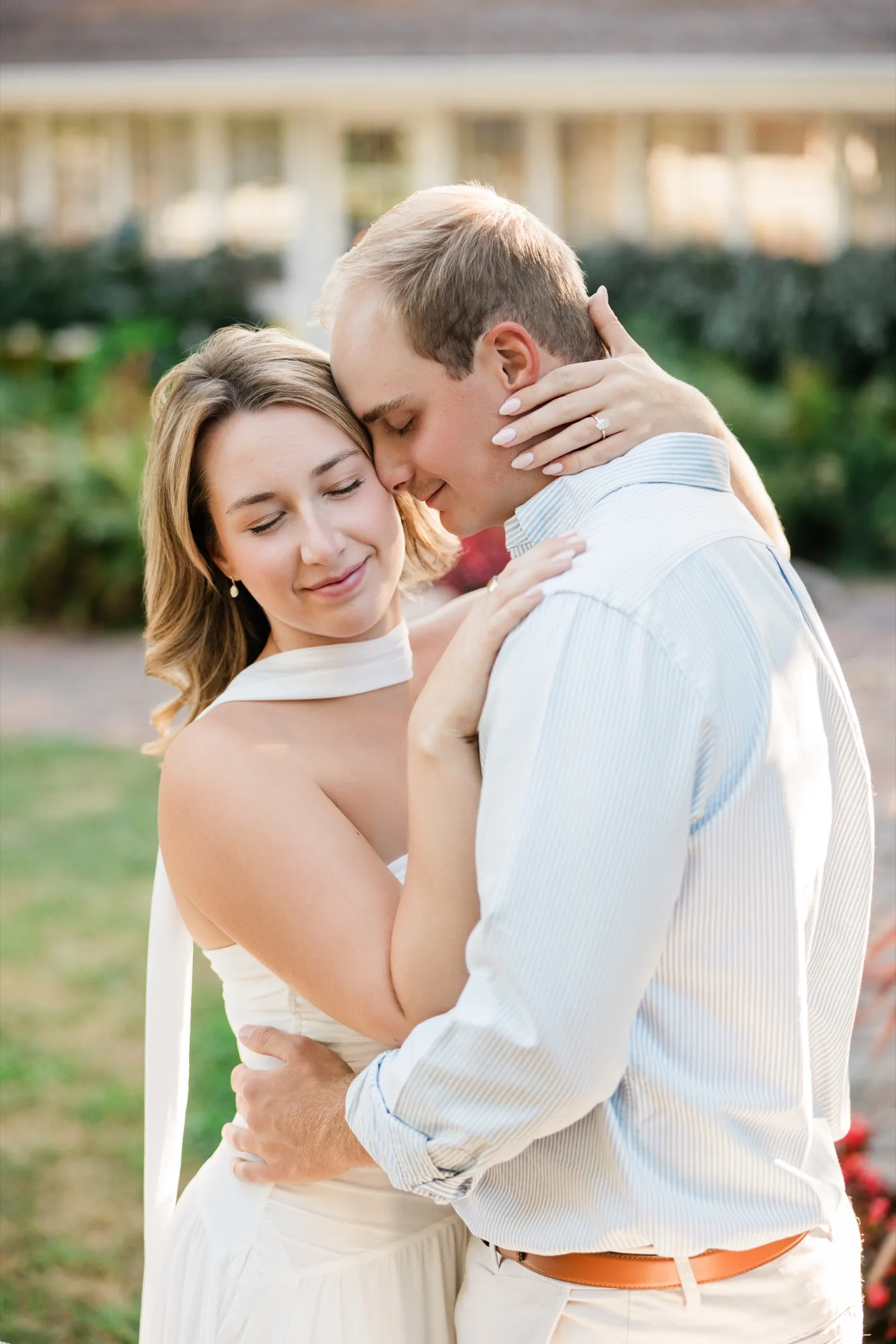 Olivia and Adam embrace with eyes closed, her hand and engagement ring resting on his neck — Tim Larsen Photography