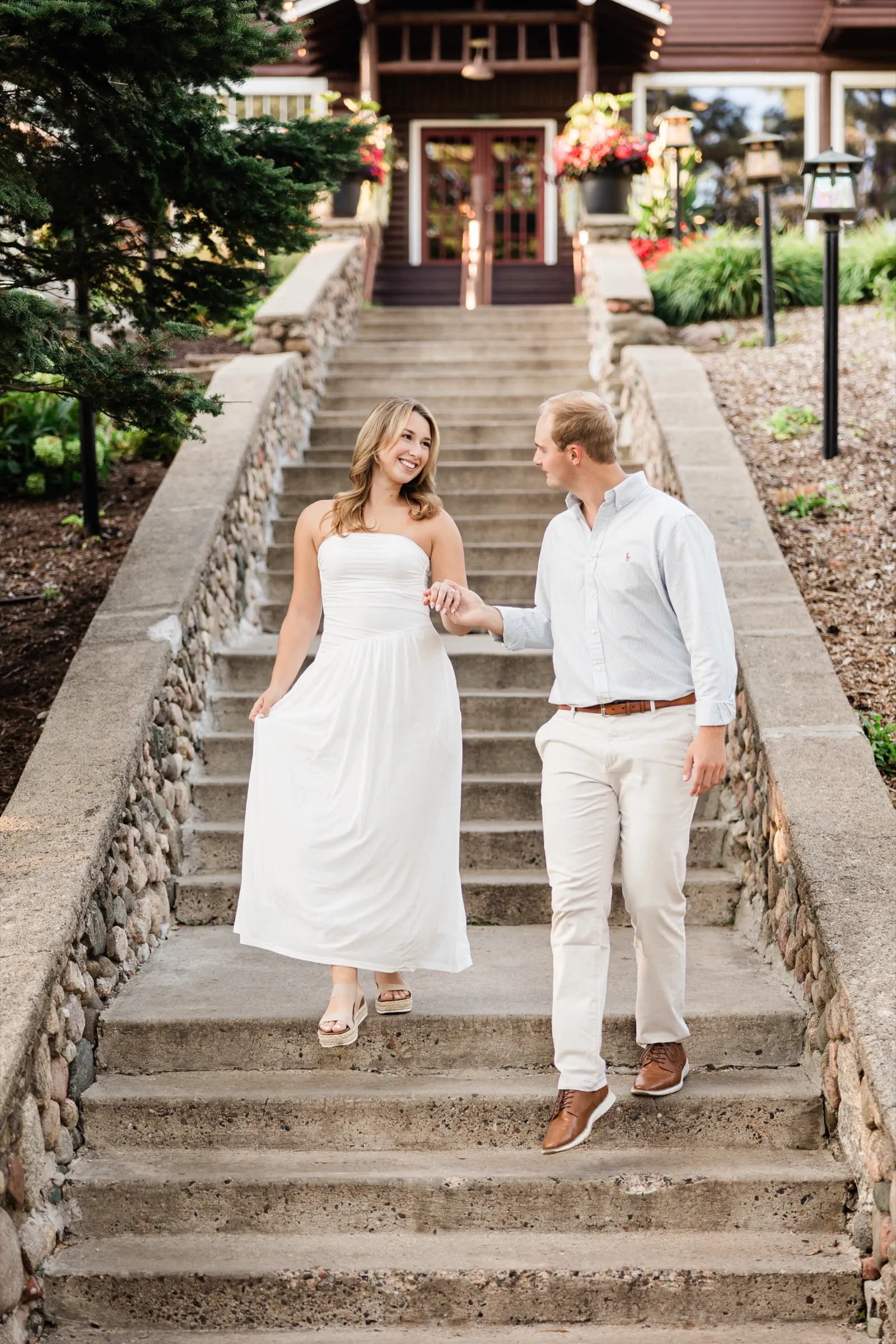 Olivia and Adam walk down the stone staircase below the historic Grand View Lodge, hand in hand — Tim Larsen Photography