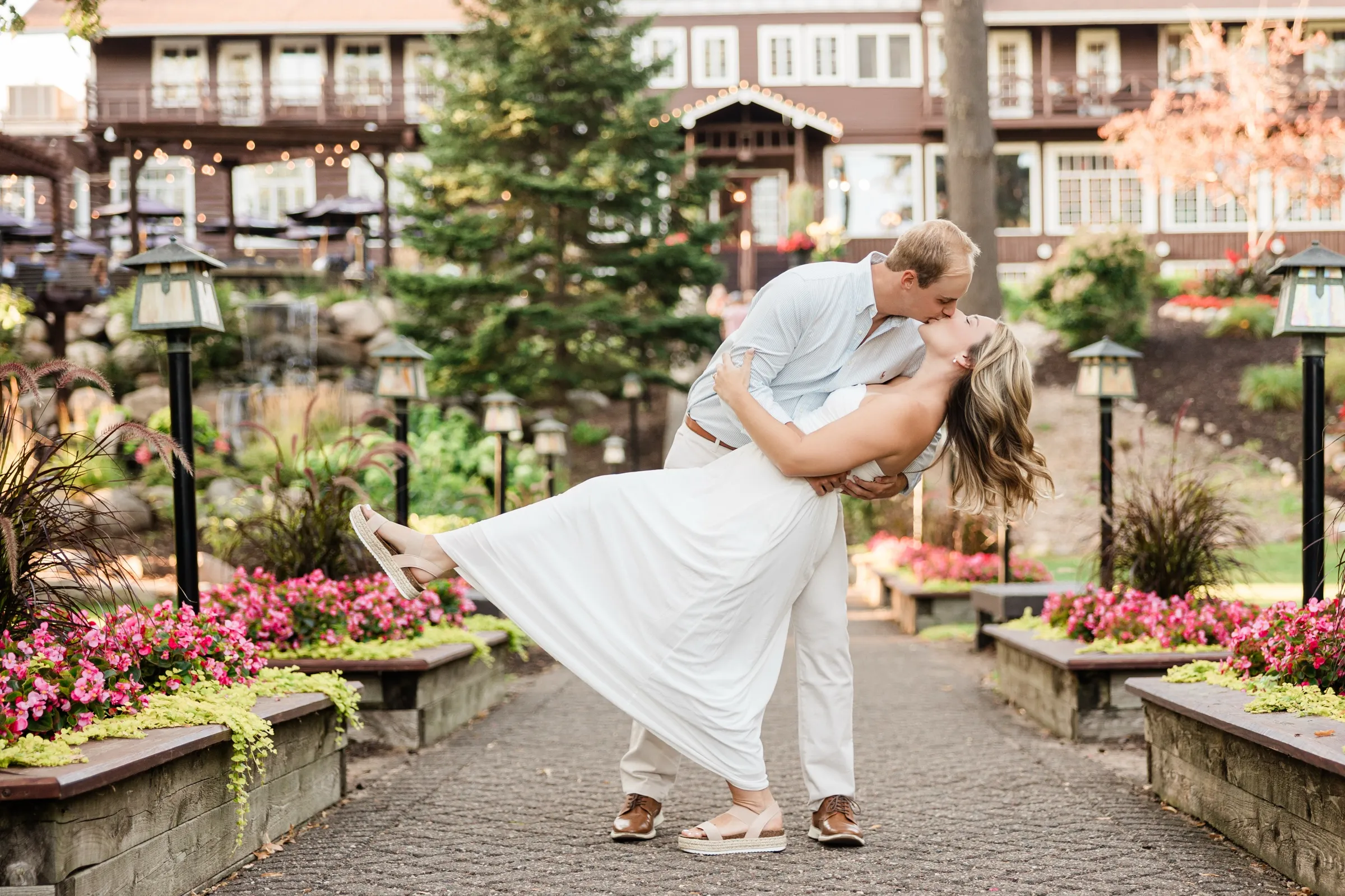 Adam dips Olivia into a kiss on the flower-lined walkway below the Grand View Lodge main lodge — Tim Larsen Photography