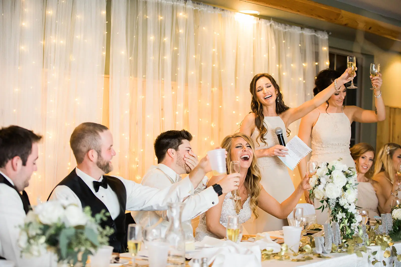Black-and-white cabin chapel recessional, guests applauding from both sides — Tim Larsen Photography, Brainerd Lakes MN