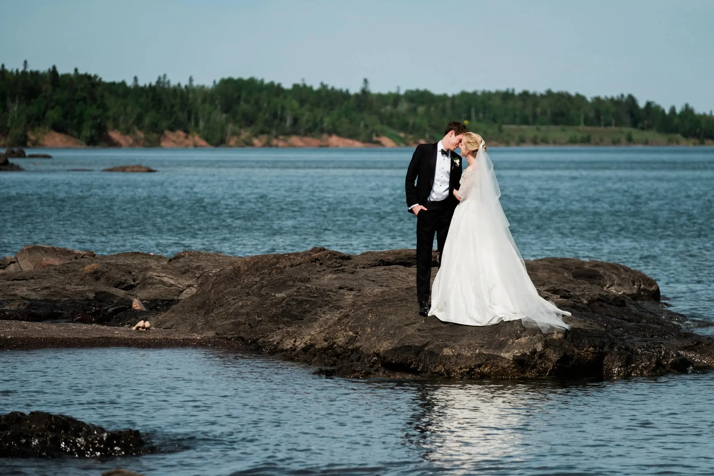Couple on volcanic rock along the Lake Superior shoreline, veil catching the breeze — Tim Larsen Photography, Brainerd Lakes MN
