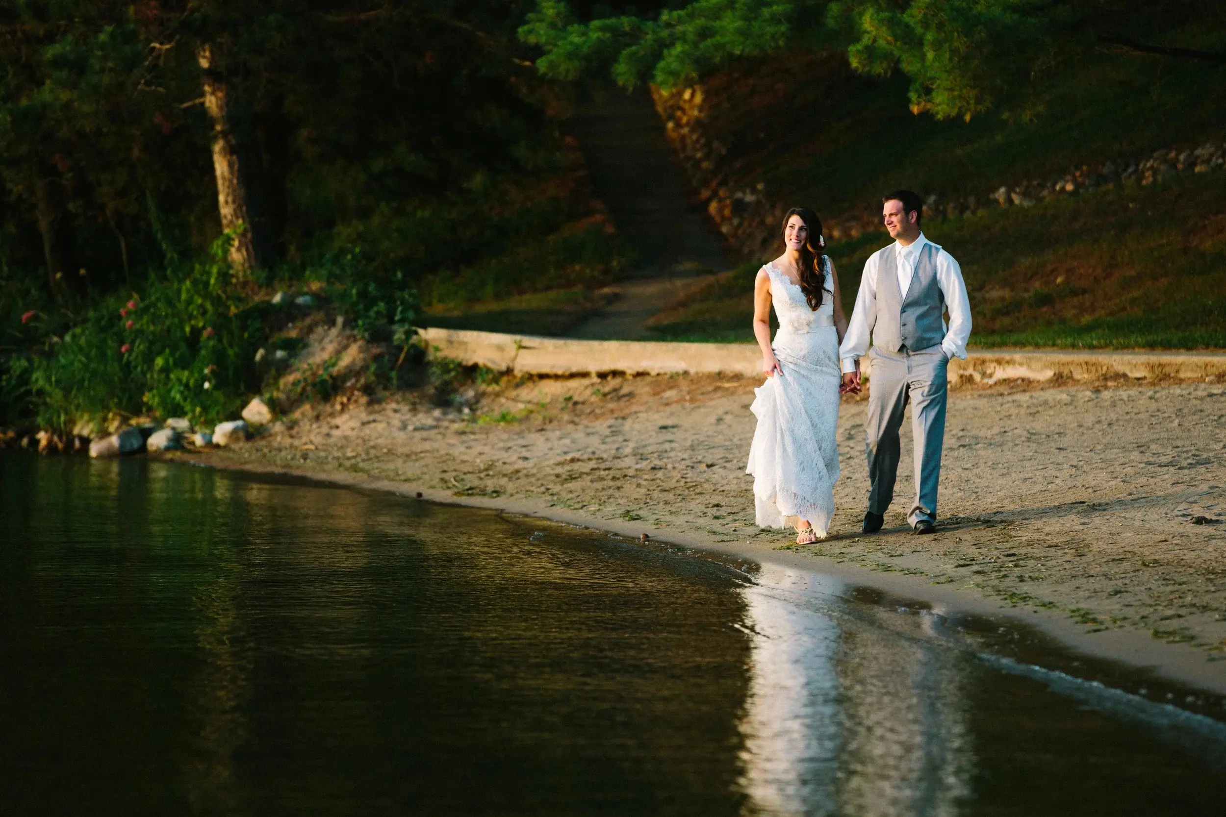 Couple walking along the shoreline at sunset, reflection in the wet sand — Tim Larsen Photography, Brainerd Lakes MN