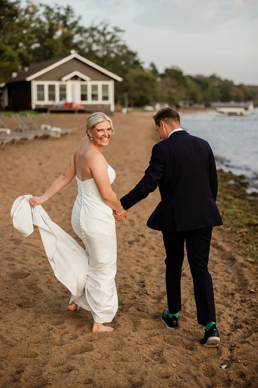 Bride walking barefoot on the beach at a Brainerd Lakes wedding — Tim Larsen Photography, Brainerd Lakes MN