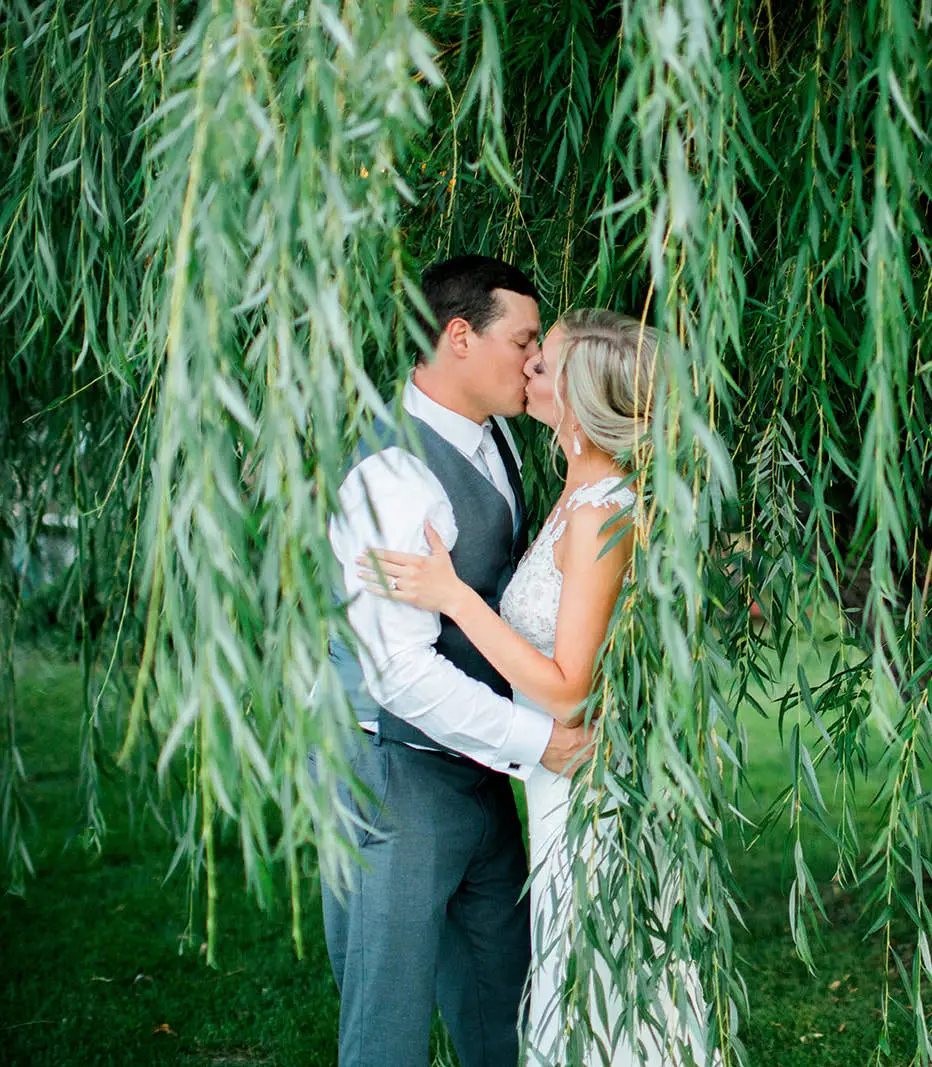 Couple kissing beneath a curtain of willow branches — Tim Larsen Photography, Brainerd Lakes MN