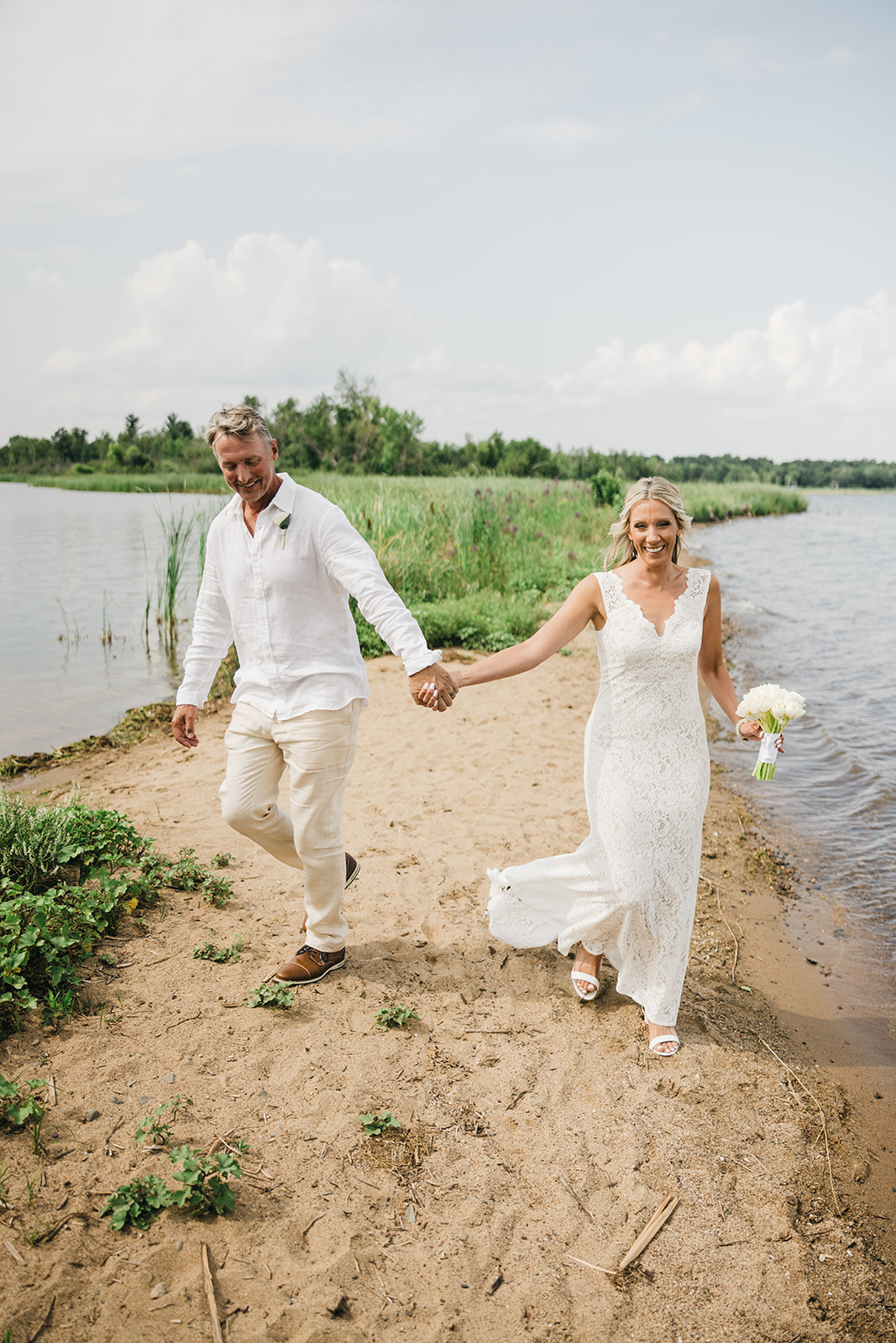 Couple walking barefoot on the beach at Pelican Lake — casual summer wedding — Tim Larsen Photography, Brainerd Lakes MN