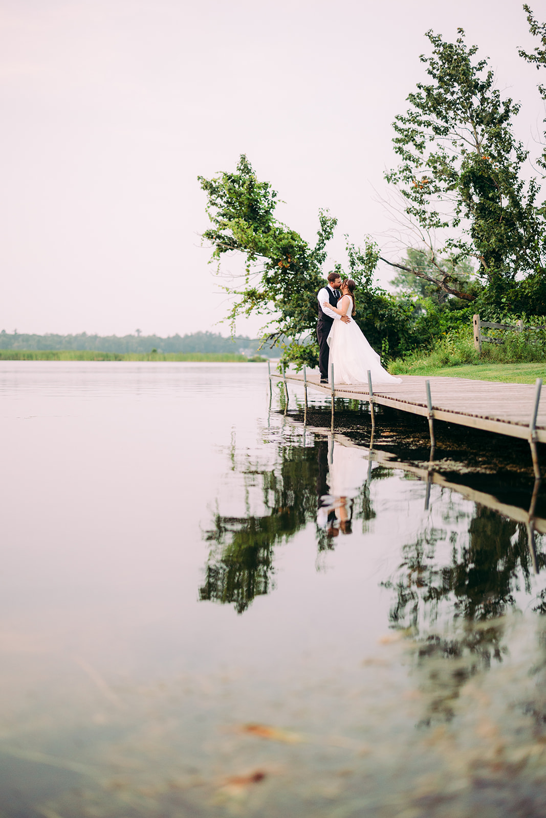Couple lift on the dock with reflection in the still water — Pelican Lake — Tim Larsen Photography, Brainerd Lakes MN