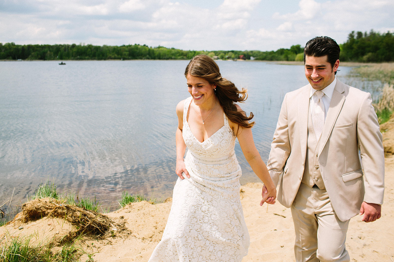 Couple laughing walking on the beach at Pelican Lake — wind in her hair — Tim Larsen Photography, Brainerd Lakes MN