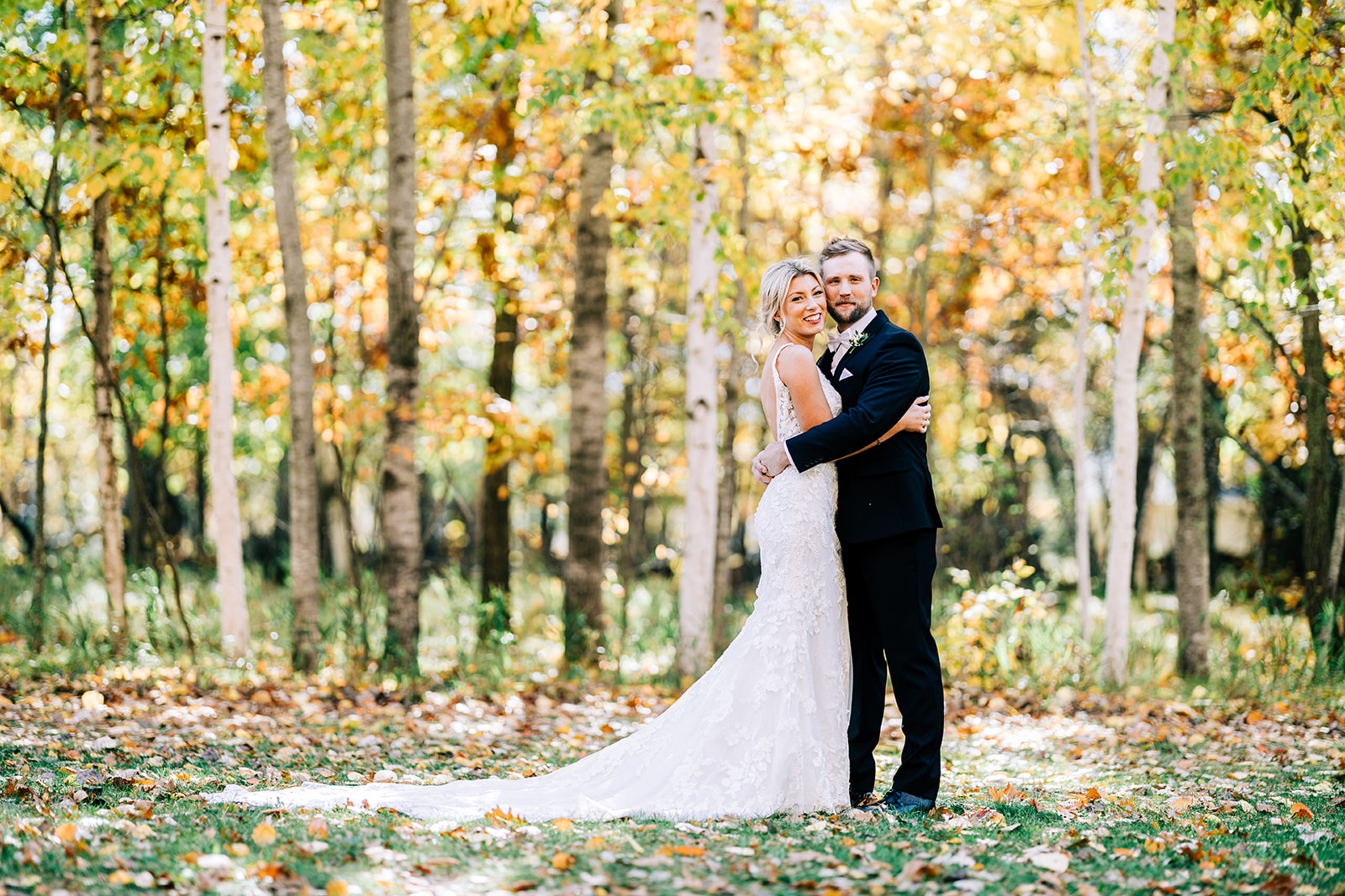 Couple embracing in the fall birch grove — golden leaves and afternoon light — Tim Larsen Photography, Brainerd Lakes MN