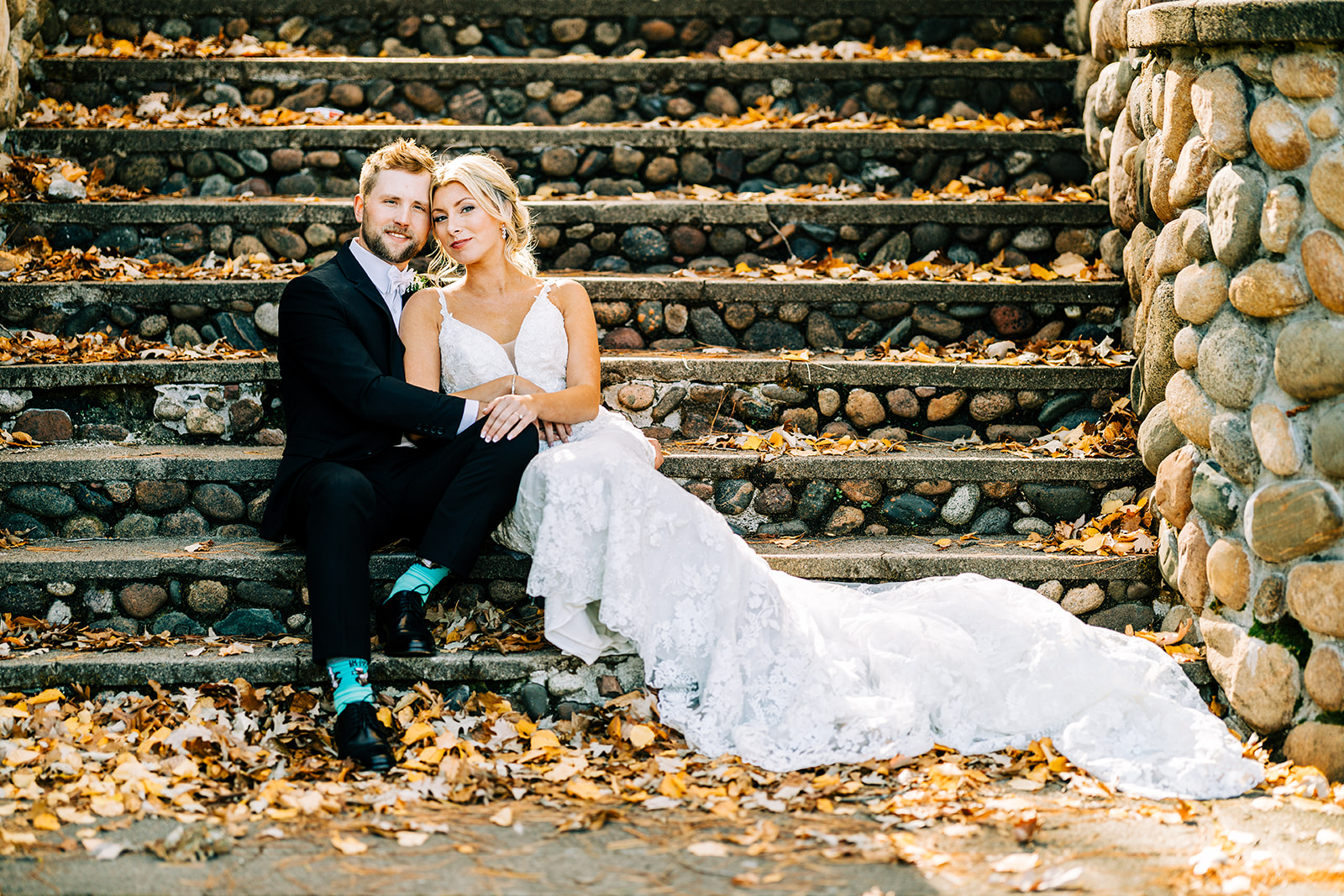 Couple sitting on stone steps covered in fall leaves at Breezy Point Resort — Tim Larsen Photography, Brainerd Lakes MN