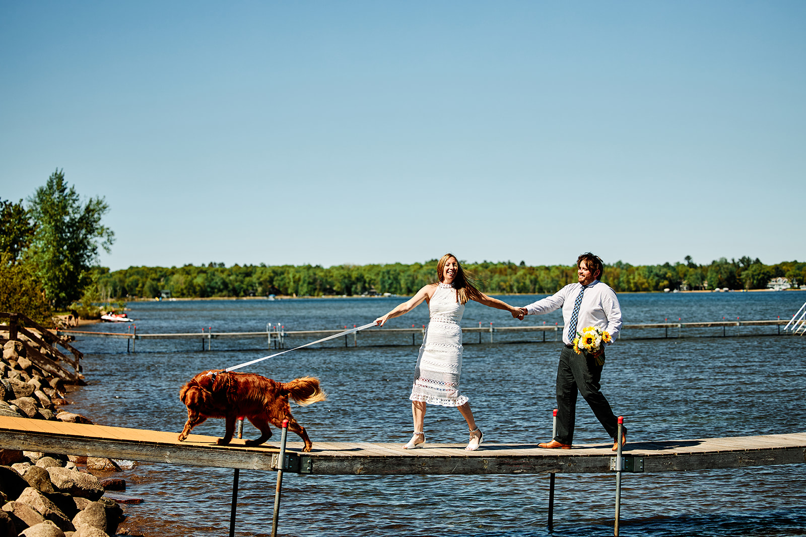 Couple walking on the dock with golden retriever — lake and blue sky — Tim Larsen Photography, Brainerd Lakes MN