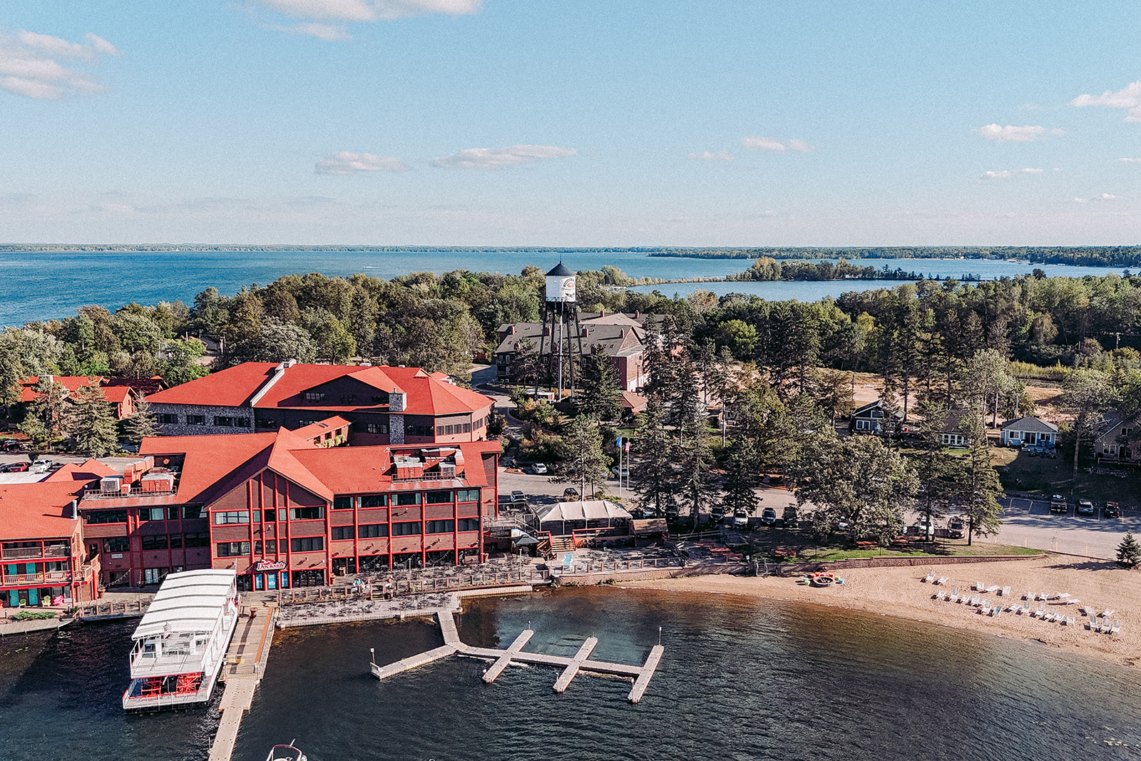Aerial view of Breezy Point Resort — red roofs, beach, marina, and Pelican Lake — Tim Larsen Photography, Brainerd Lakes MN