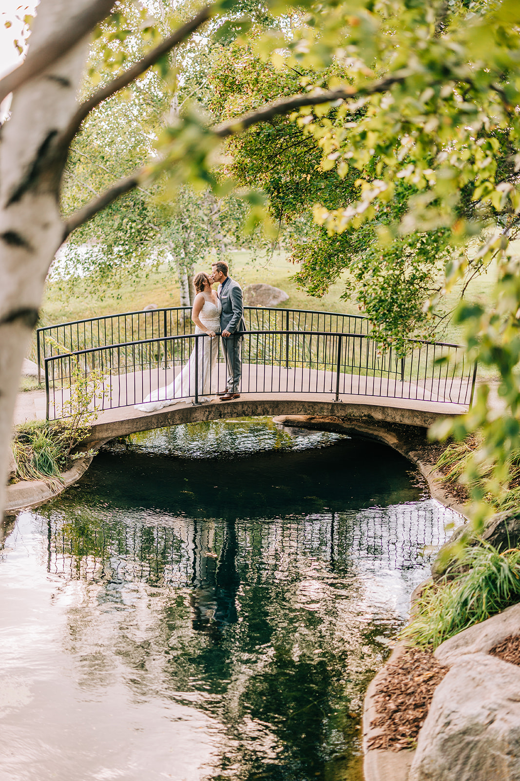 Couple on the garden footbridge with reflection in the pond below — Tim Larsen Photography, Brainerd Lakes MN