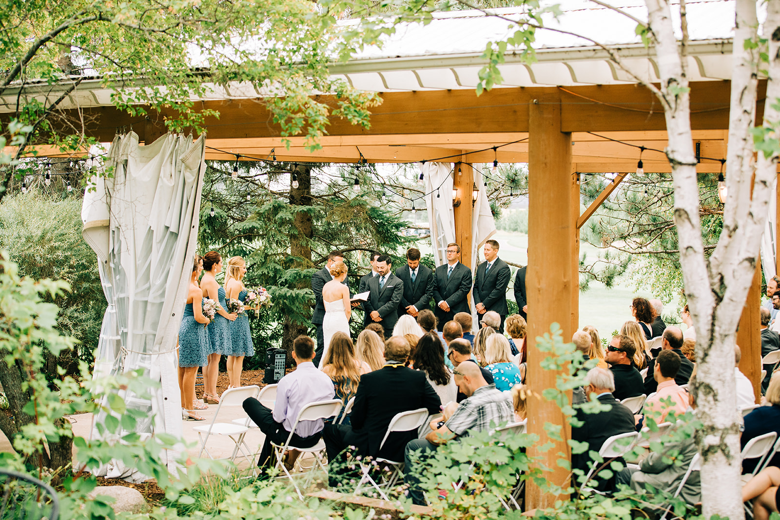 Garden pergola ceremony with draping and birch trees at Breezy Point — Tim Larsen Photography, Brainerd Lakes MN
