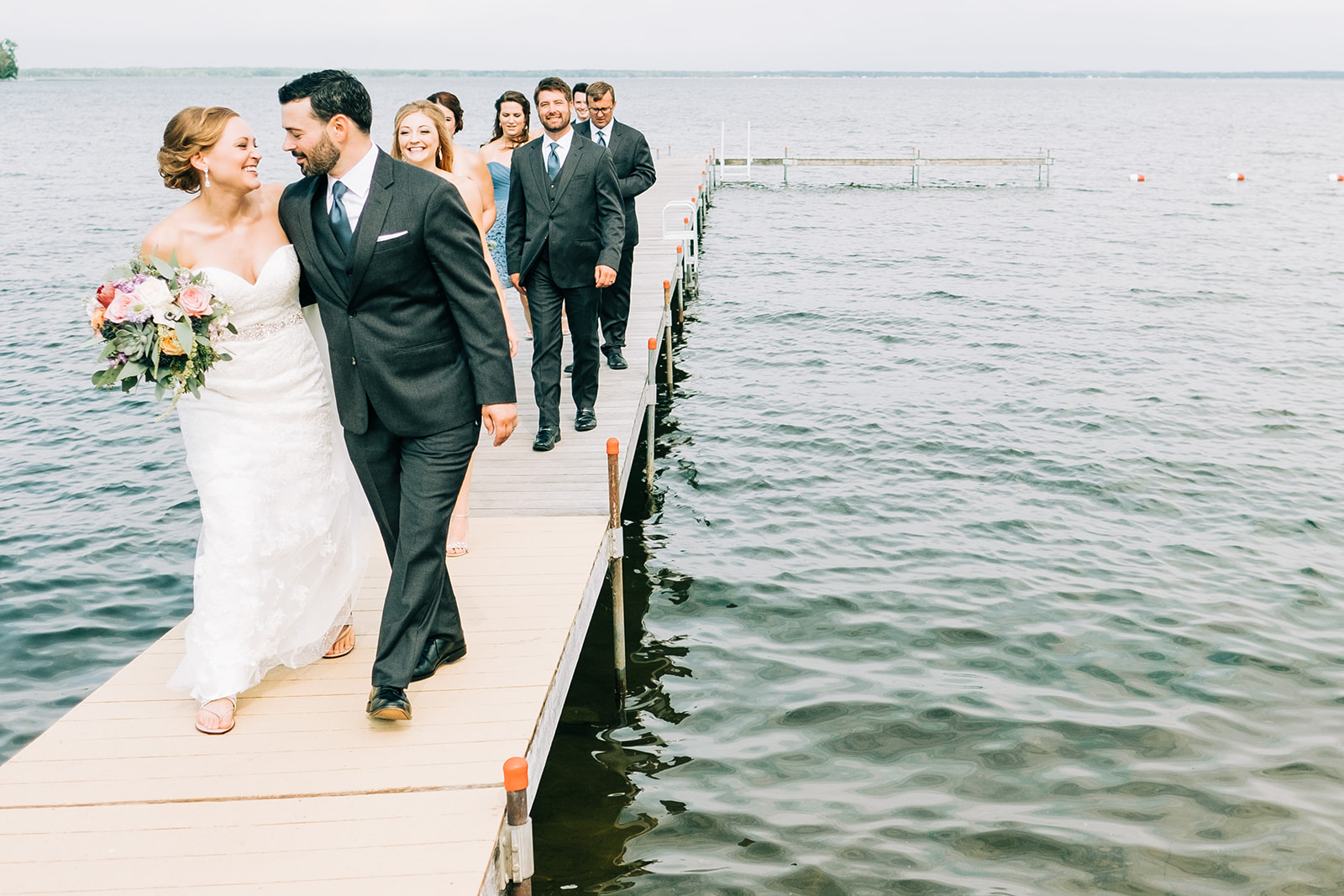 Couple and wedding party walking on the dock on Pelican Lake — Tim Larsen Photography, Brainerd Lakes MN