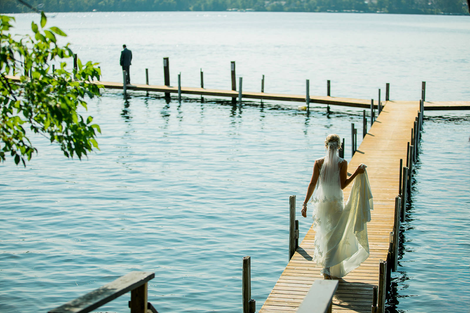 Bride walking down the dock toward groom — first look on Gull Lake — Tim Larsen Photography, Brainerd Lakes MN