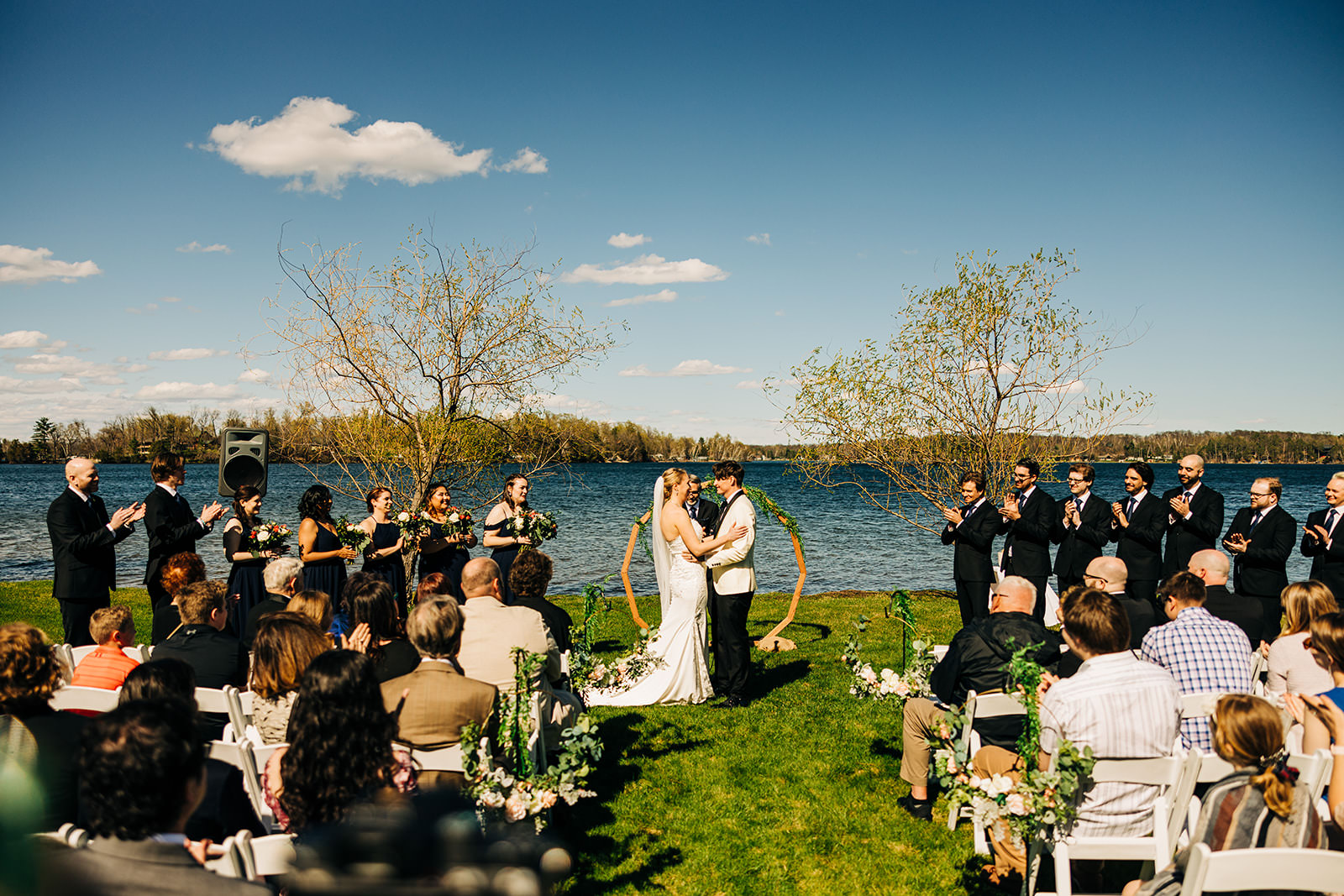 North Lawn ceremony with gold circle arch — Steamboat Bay and Gull Lake behind — Tim Larsen Photography, Brainerd Lakes MN