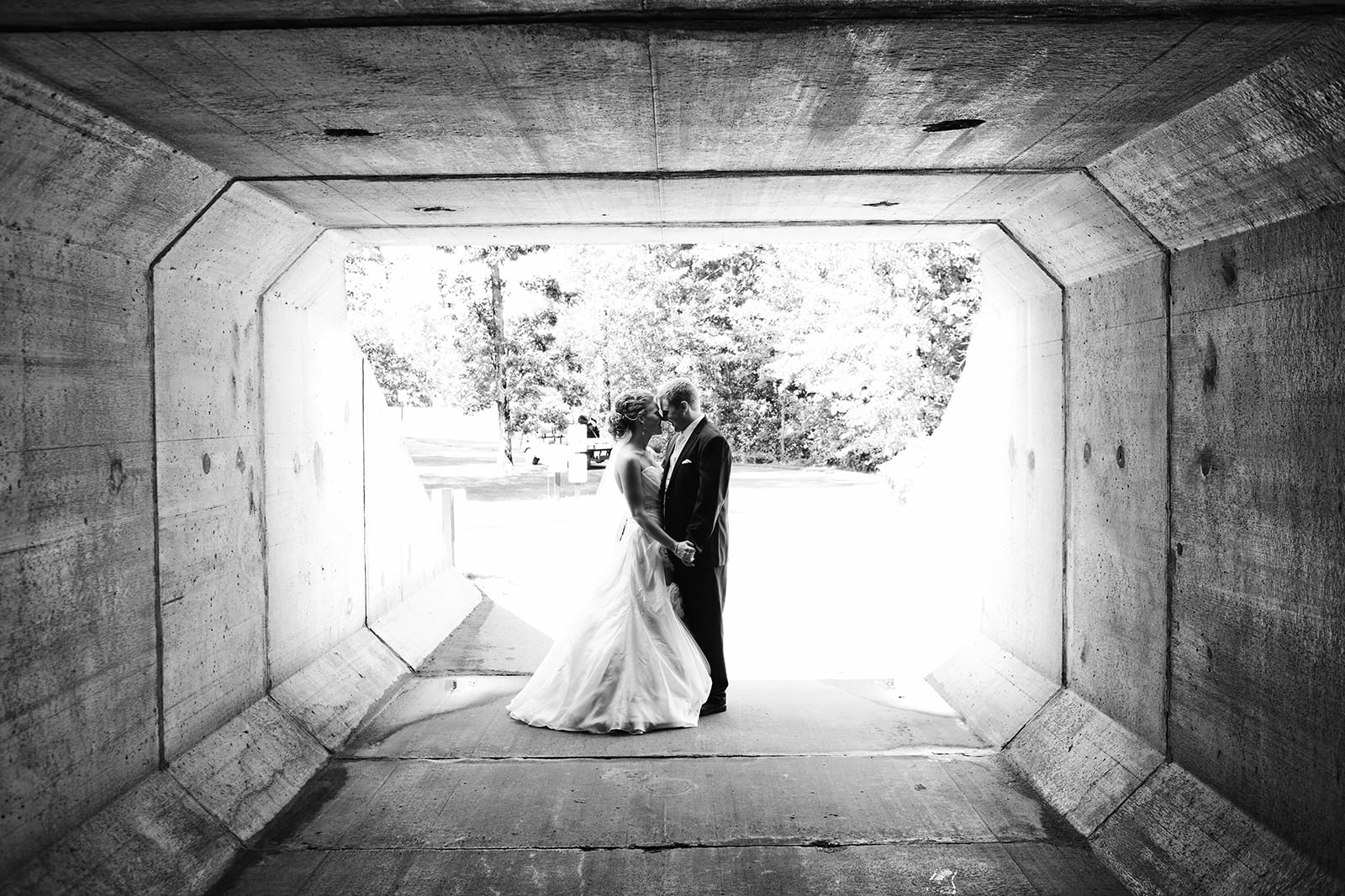 Couple silhouette in a concrete tunnel — black and white, dramatic light — Tim Larsen Photography, Brainerd Lakes MN
