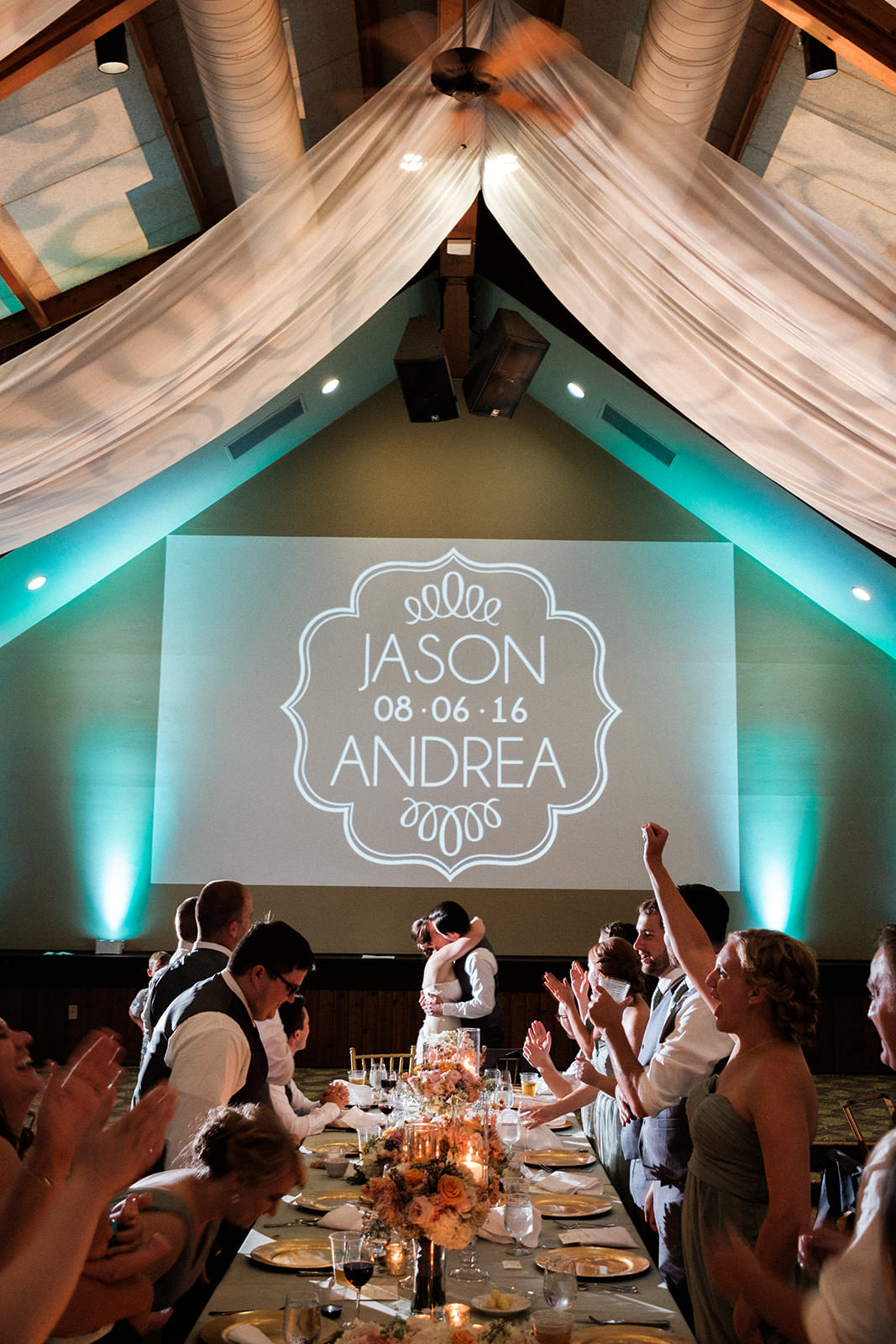 Reception in the Norway Center — teal uplighting and monogram projection — Tim Larsen Photography, Brainerd Lakes MN