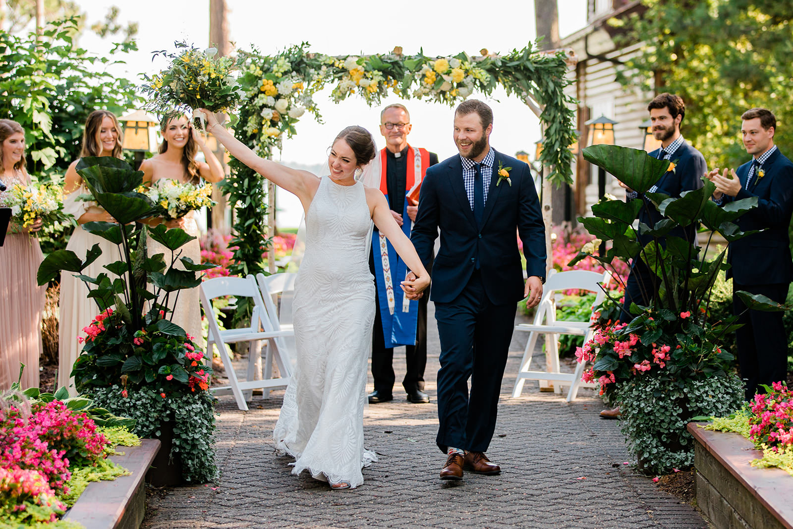 Grand Staircase recessional — couple walking up the aisle through flowers and greenery — Tim Larsen Photography, Brainerd Lakes MN
