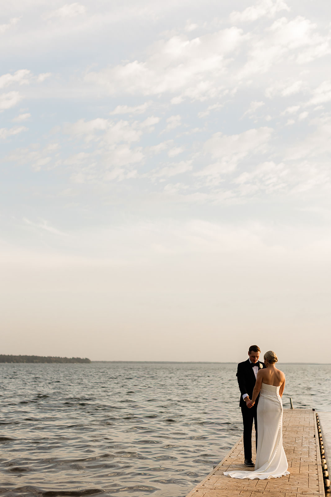Couple standing on the dock looking out over Gull Lake — open sky and water — Tim Larsen Photography, Brainerd Lakes MN