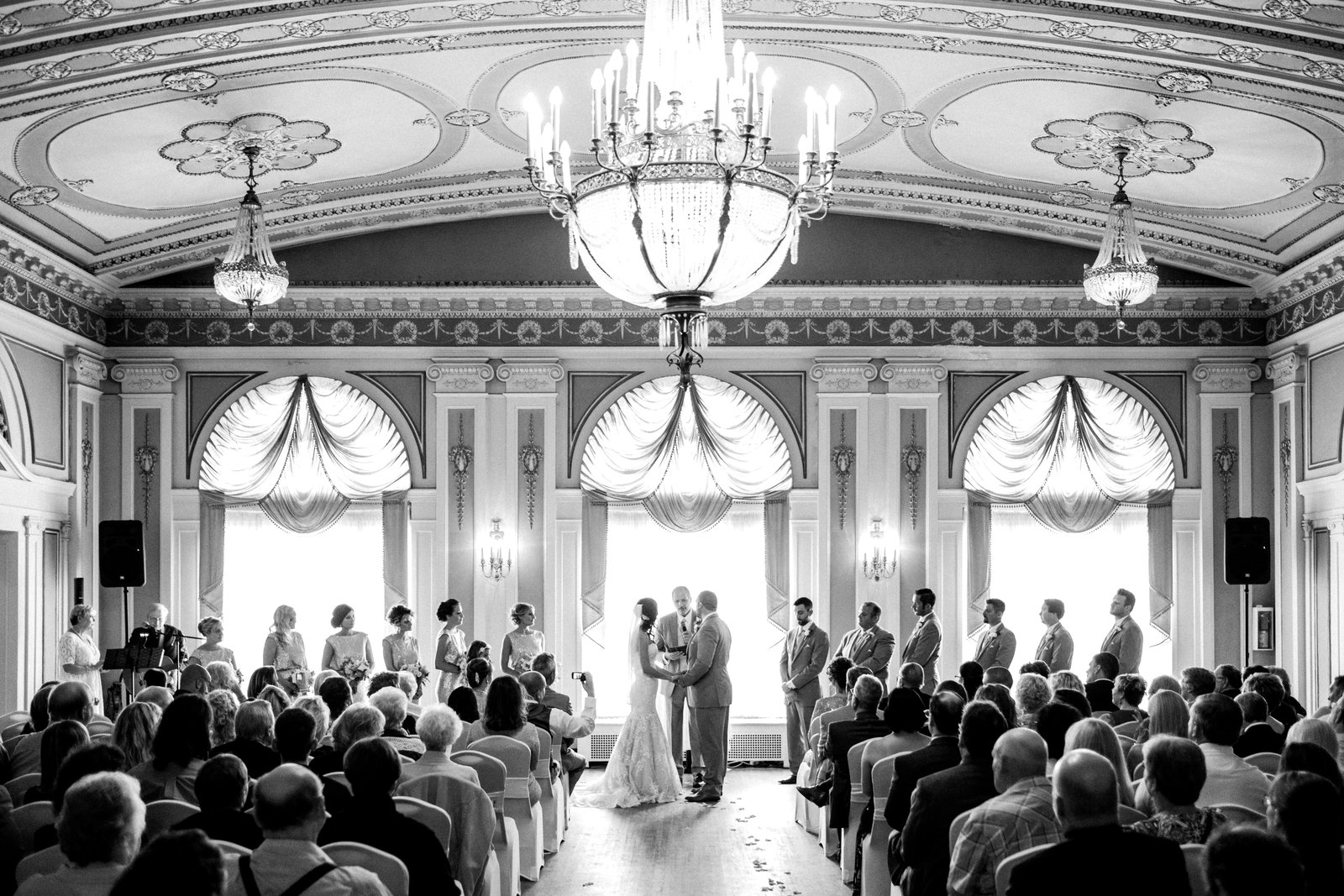 Ceremony in the historic Greysolon Ballroom — autumn wedding under chandeliers — Tim Larsen Photography, Duluth MN