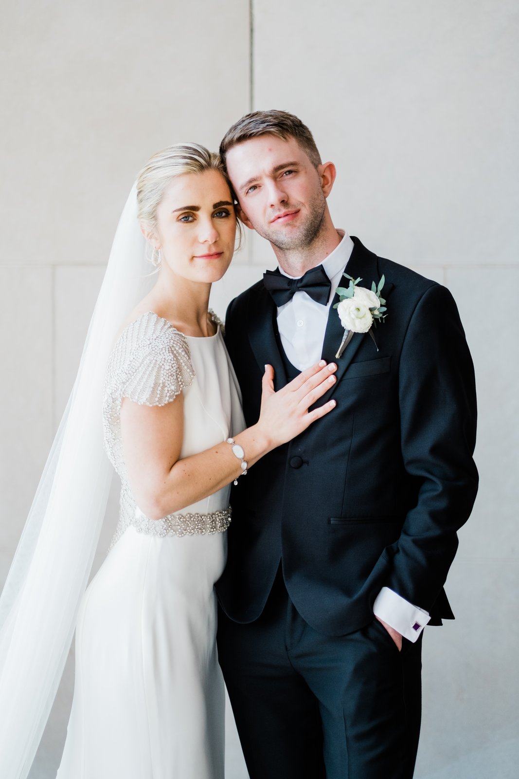 Tight half-body couples portrait — bride's hand resting on the groom's chest, soft directional window light — Tim Larsen Photography, Duluth MN