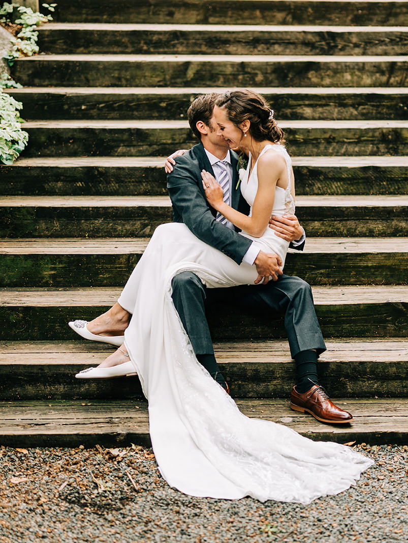 Couple sitting on stone steps in the garden — intimate moment between portraits — Tim Larsen Photography, Brainerd Lakes MN