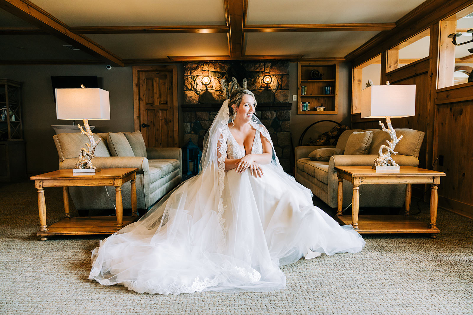 Bride in the lodge getting ready — cathedral veil and warm wood interior — Tim Larsen Photography, Brainerd Lakes MN