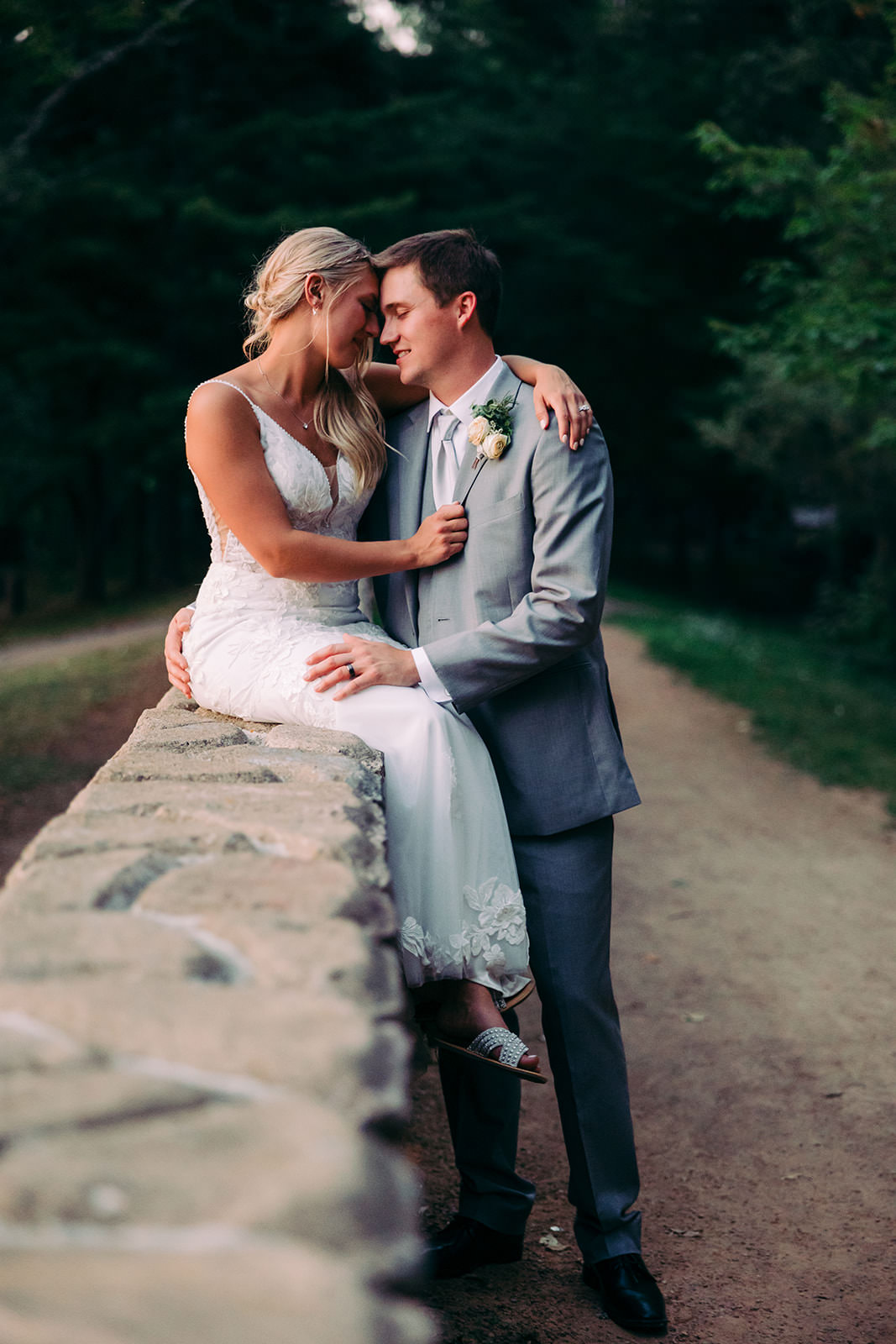 Couple on the stone wall path through the gardens at Manhattan Beach Lodge — Tim Larsen Photography, Brainerd Lakes MN