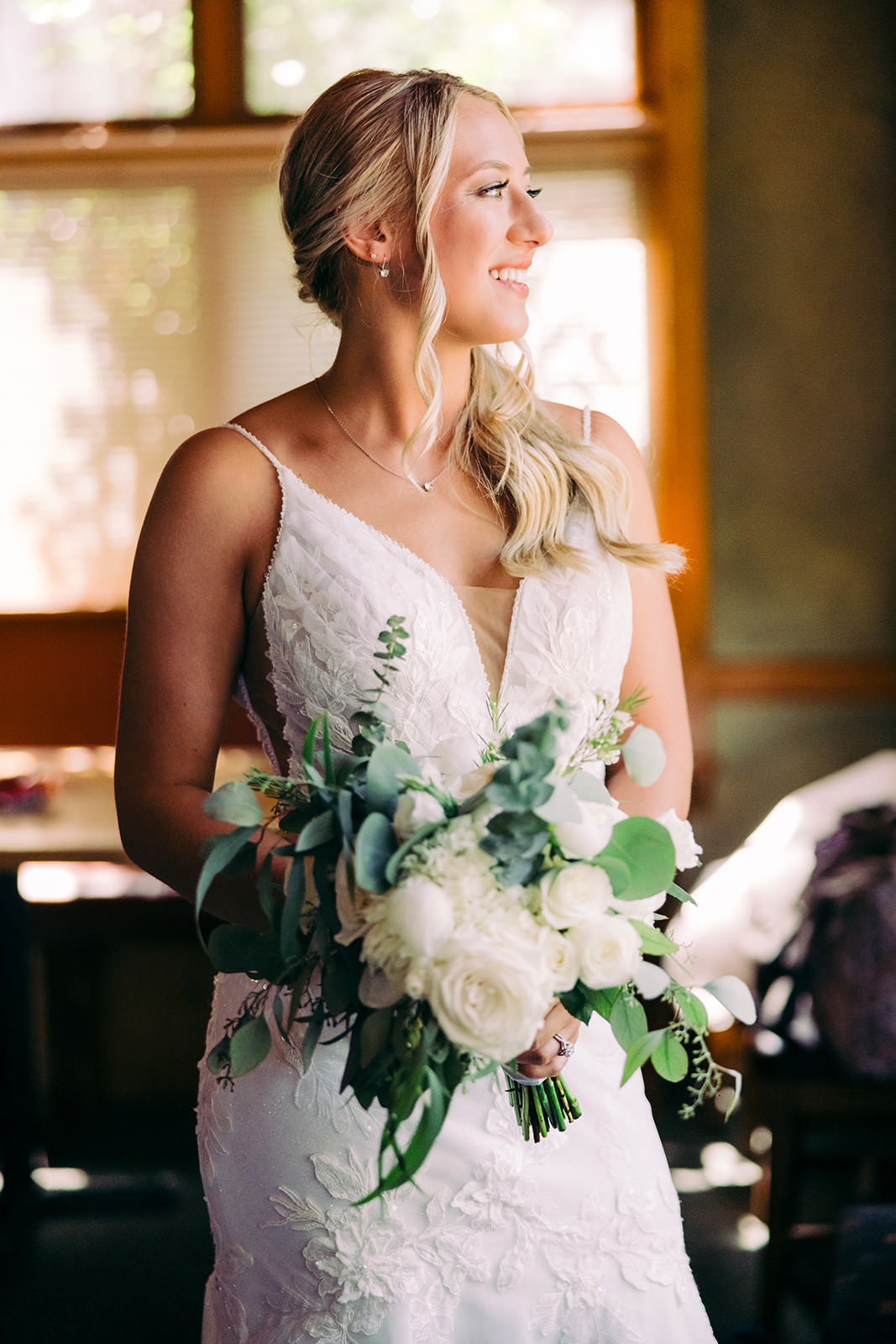 Bride with white rose bouquet in warm window light — getting ready at the lodge — Tim Larsen Photography, Brainerd Lakes MN
