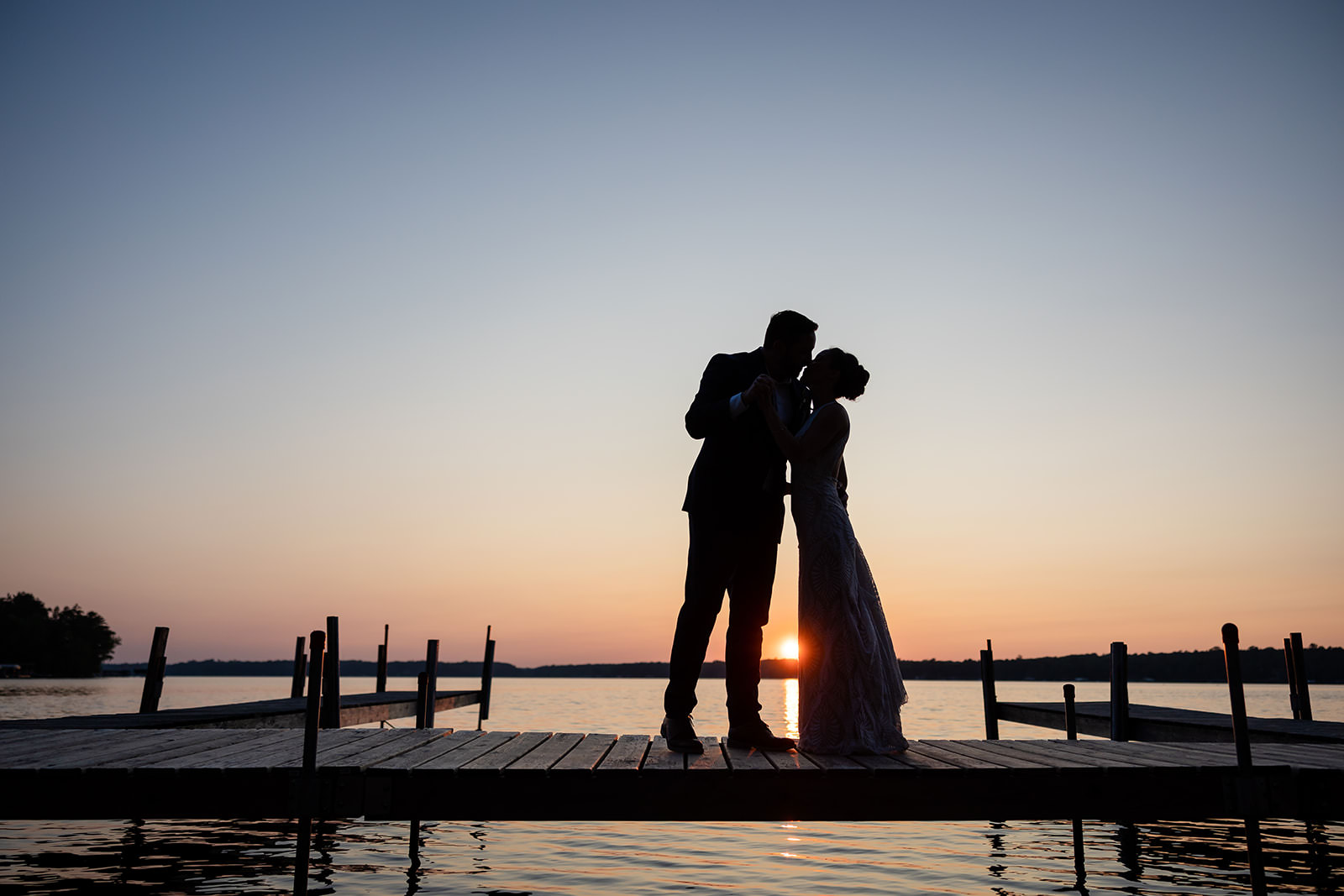 Couple silhouette kissing on the dock at sunset — Big Trout Lake — Tim Larsen Photography, Brainerd Lakes MN